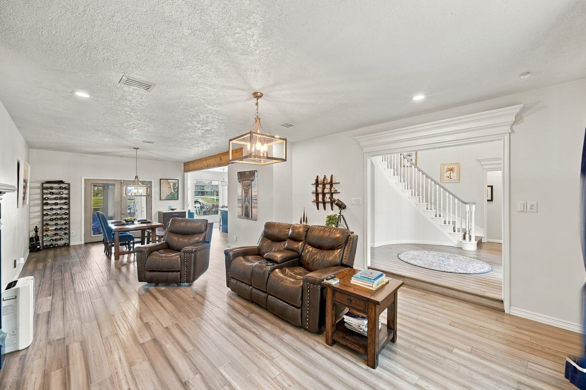 932 Plantation Street, League City, TX 77573 The spacious living area has an open-concept layout that flows into the kitchen and dining areas.
