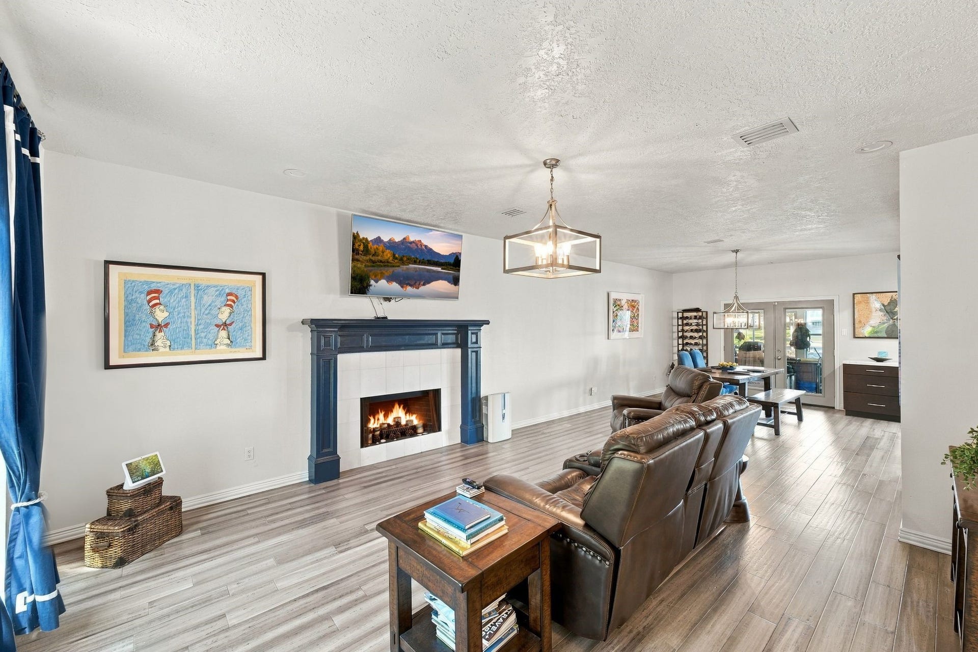 932 Plantation Street, League City, TX 77573 The family room features a wood-burning fireplace and updated flooring.