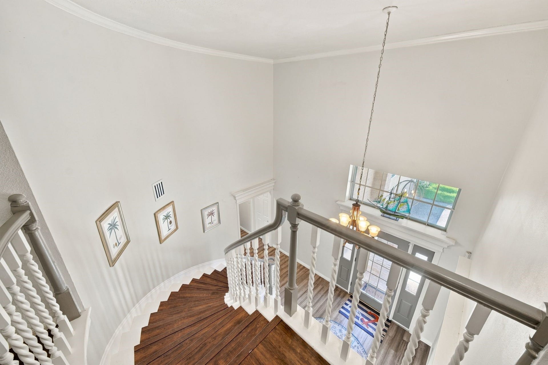 932 Plantation Street, League City, TX 77573 The spiral staircase leads to the second floor and overlooks the grand entry below.