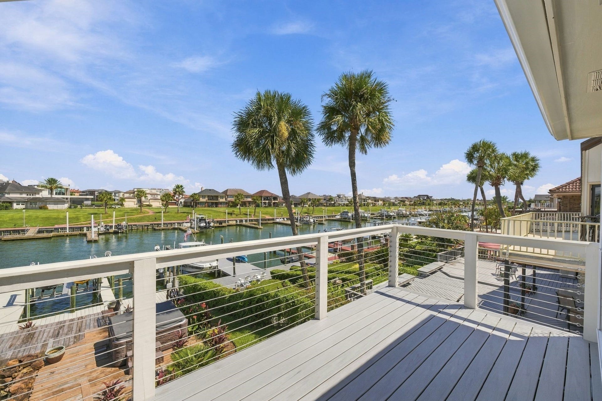 932 Plantation Street, League City, TX 77573 The private balcony overlooks open water and palm trees.