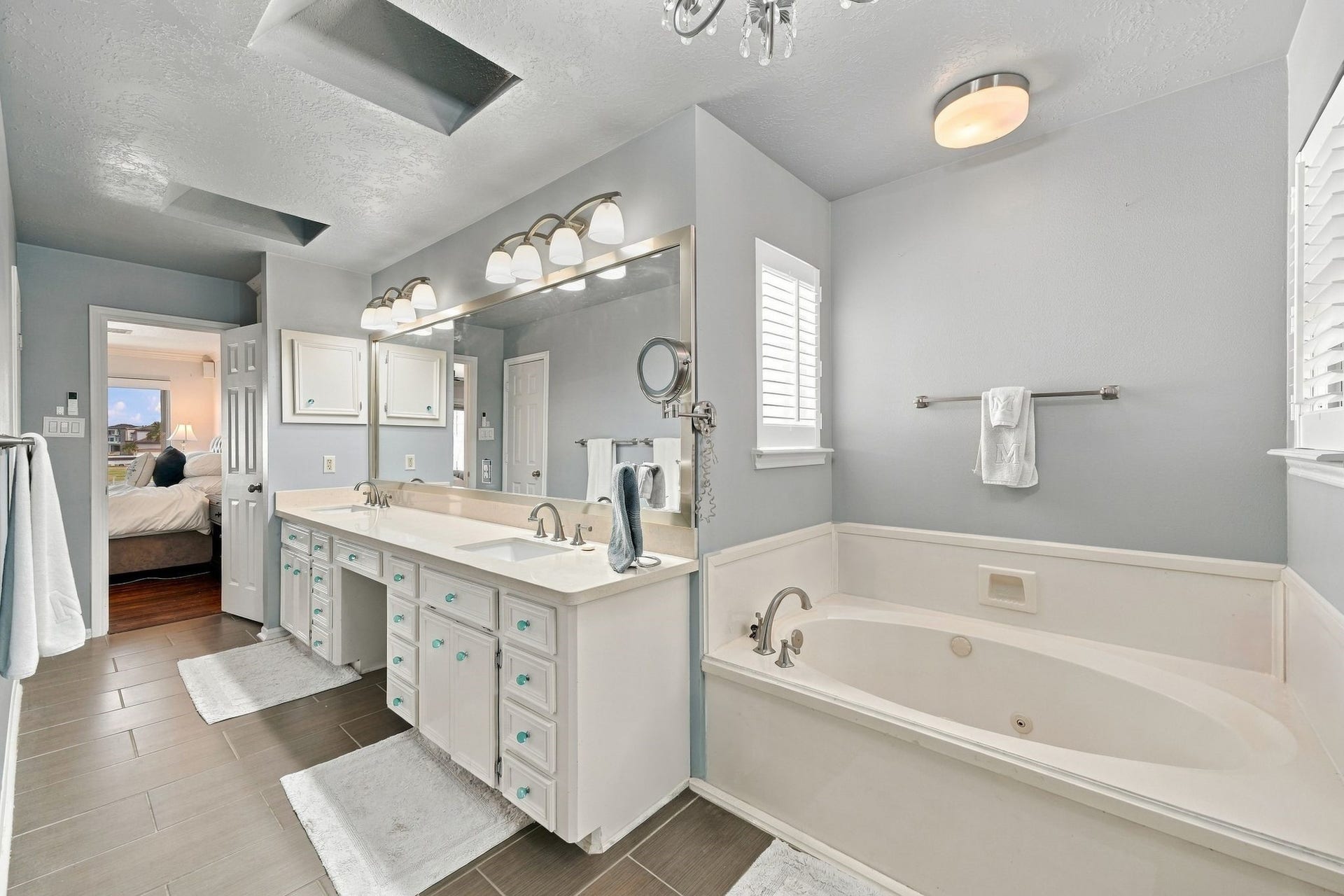 932 Plantation Street, League City, TX 77573 The primary bath features a soaking tub, dual vanity sinks, and a built-in makeup vanity.