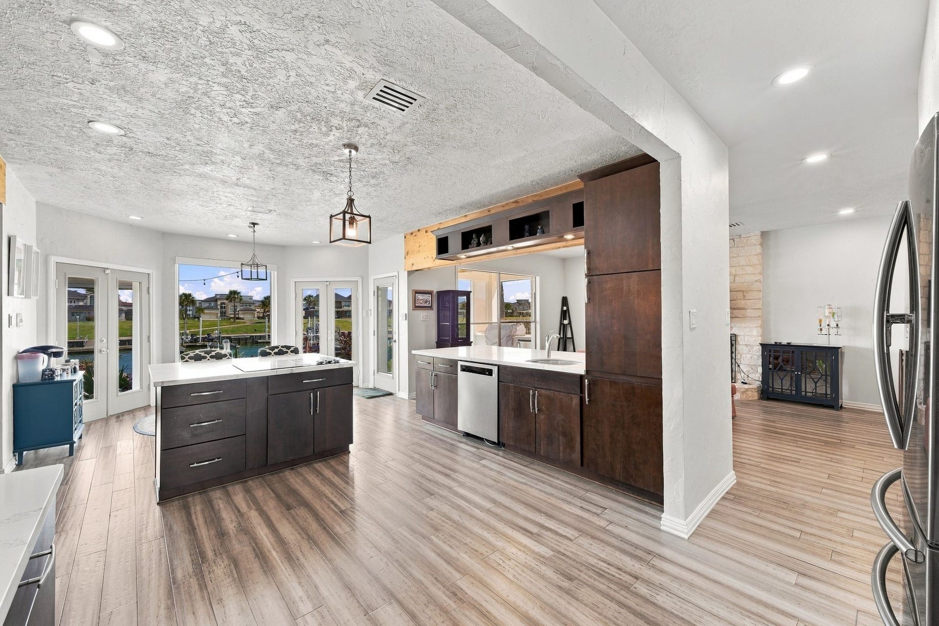 932 Plantation Street, League City, TX 77573 The kitchen is open to the family room and features rich dark cabinetry and a center island.