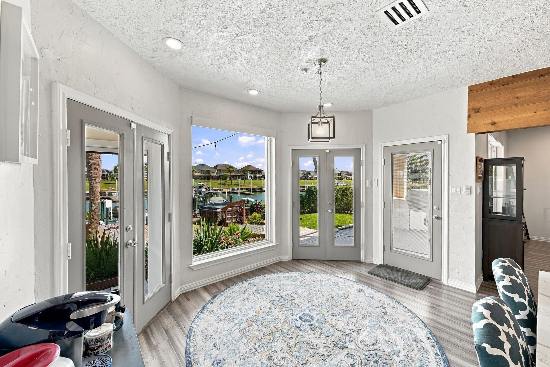 932 Plantation Street, League City, TX 77573 The breakfast nook has large windows and French doors to the backyard, filling the space with natural light.