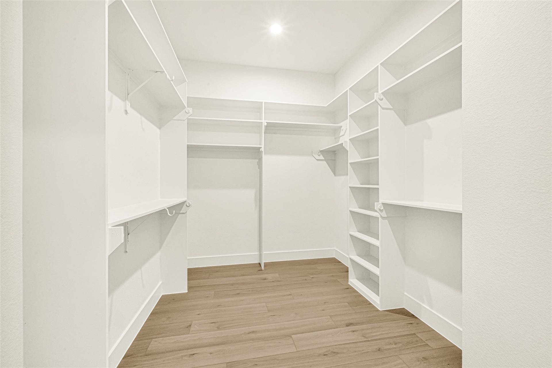 Walk in closet in primary bedroom.