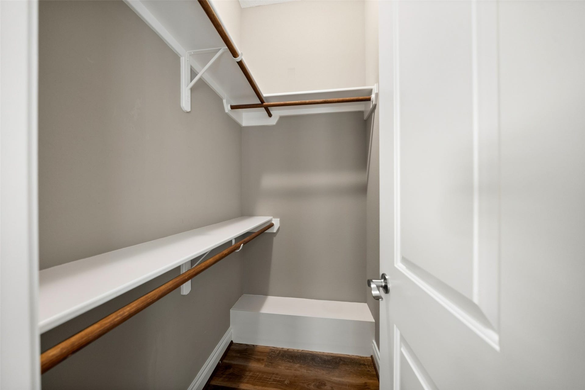 1125 Galveston Street, Hempstead, TX 77445 1. Walk-in closet featuring upper shelving, hanging rods, and wood-look flooring.