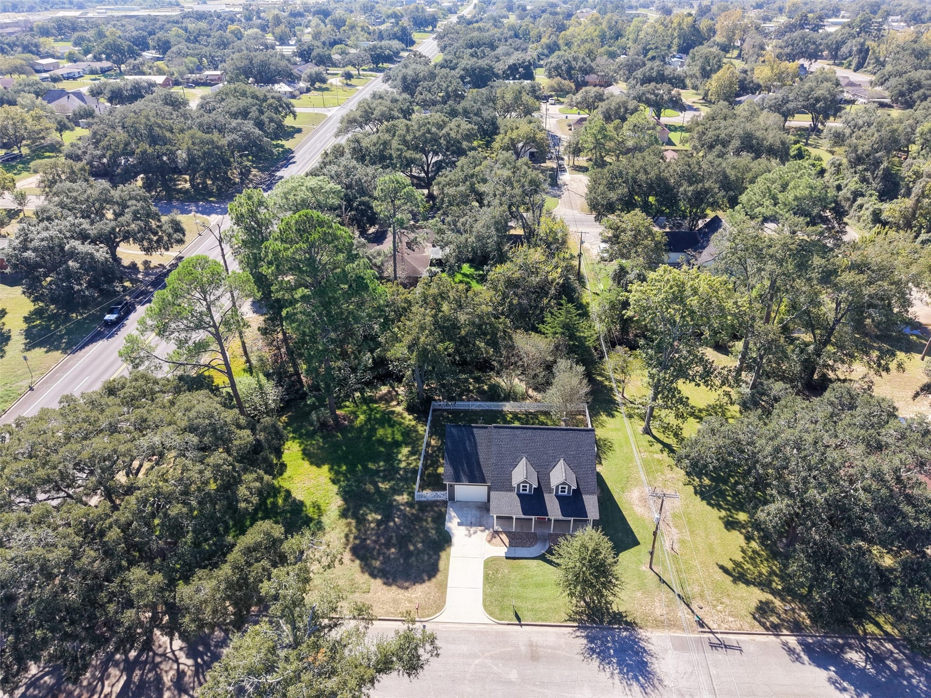 1125 Galveston Street, Hempstead, TX 77445 Overhead neighborhood view showing the propertys setting among established trees and nearby residences.