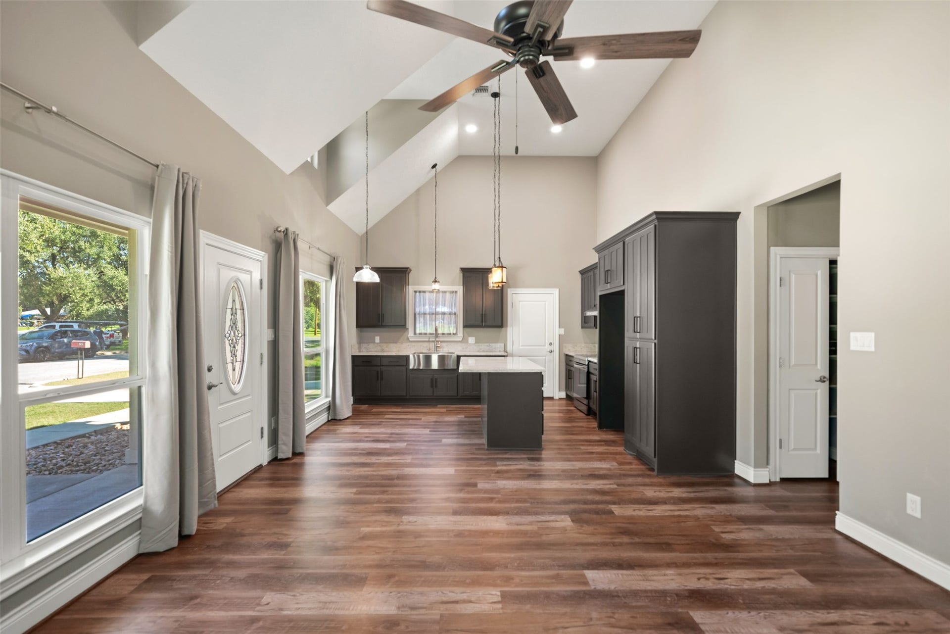 1125 Galveston Street, Hempstead, TX 77445 View toward the kitchen highlighting the open layout, large windows, and center island.