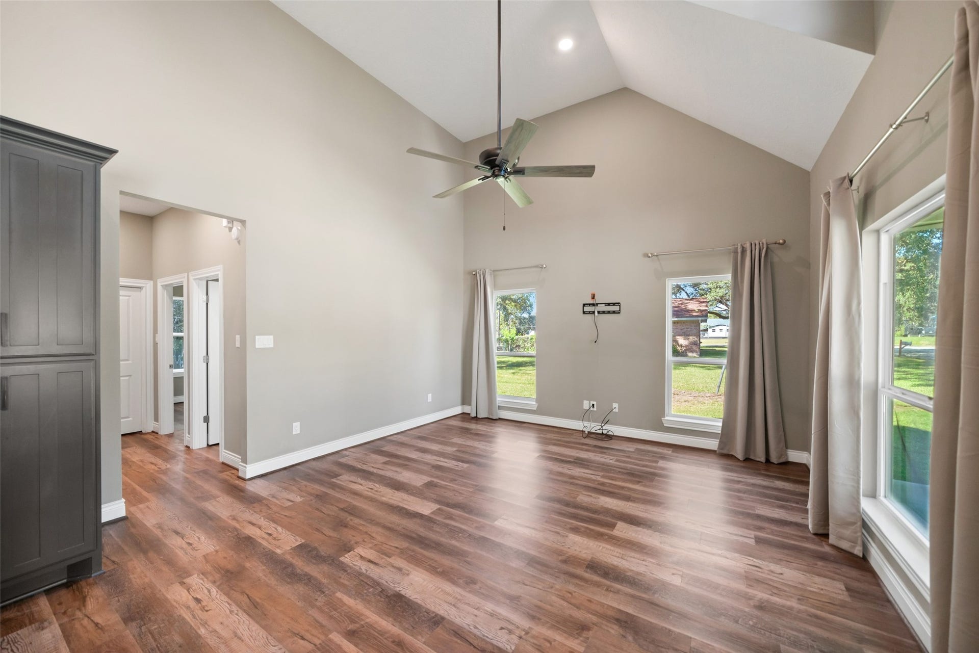 1125 Galveston Street, Hempstead, TX 77445 Alternate living area view showcasing the open layout, wood-look flooring, and connection to the kitchen.