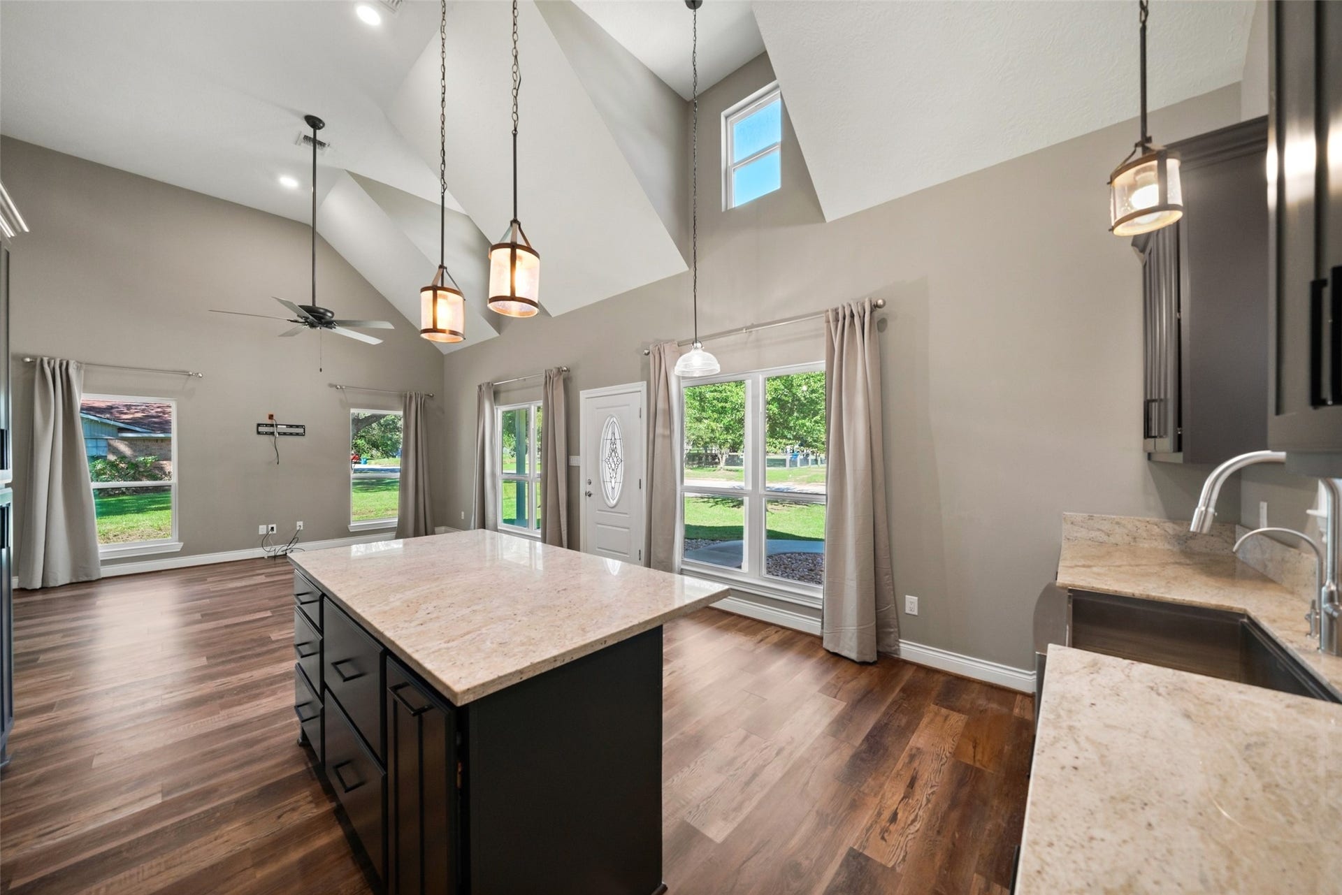 1125 Galveston Street, Hempstead, TX 77445 Open kitchen and living area featuring a center island with seating space, pendant lighting, and wood-look flooring throughout.