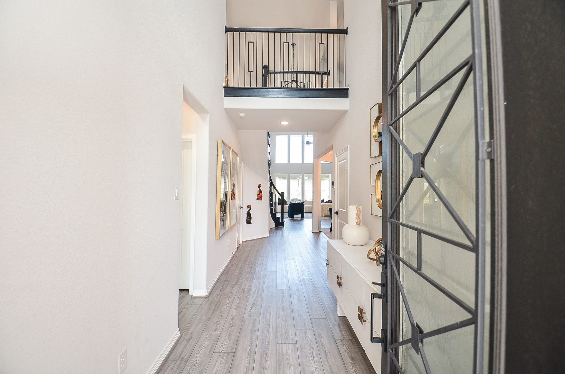 30706 Hawthorn Glen Court, Fulshear, TX 77441 Bright and inviting entryway with high ceilings, modern decor, and sleek flooring leading to an open living area.