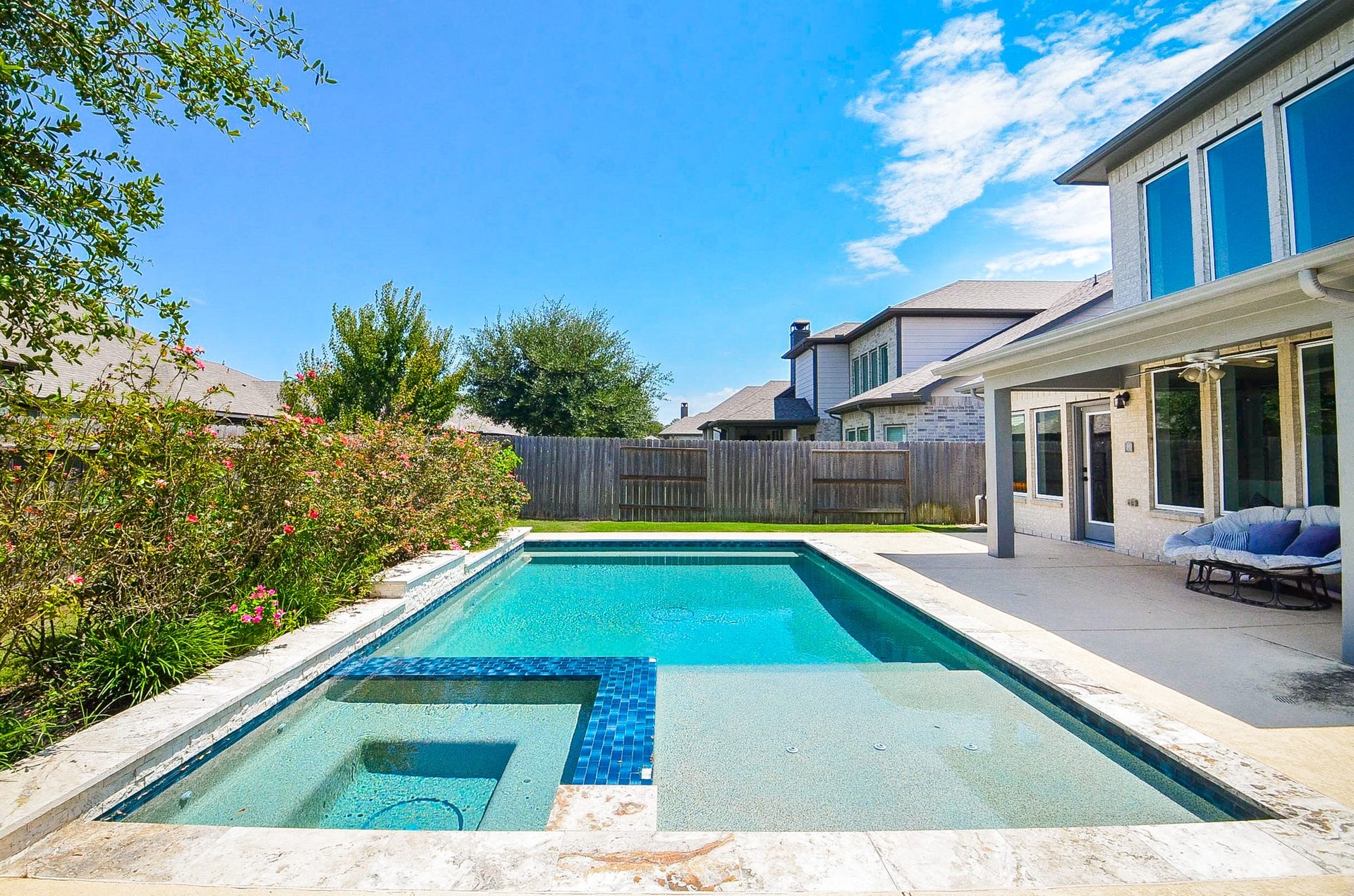 30706 Hawthorn Glen Court, Fulshear, TX 77441 Experience outdoor luxury with this stunning backyard featuring a sparkling pool, spa, and spacious patio, perfect for relaxation and entertaining.