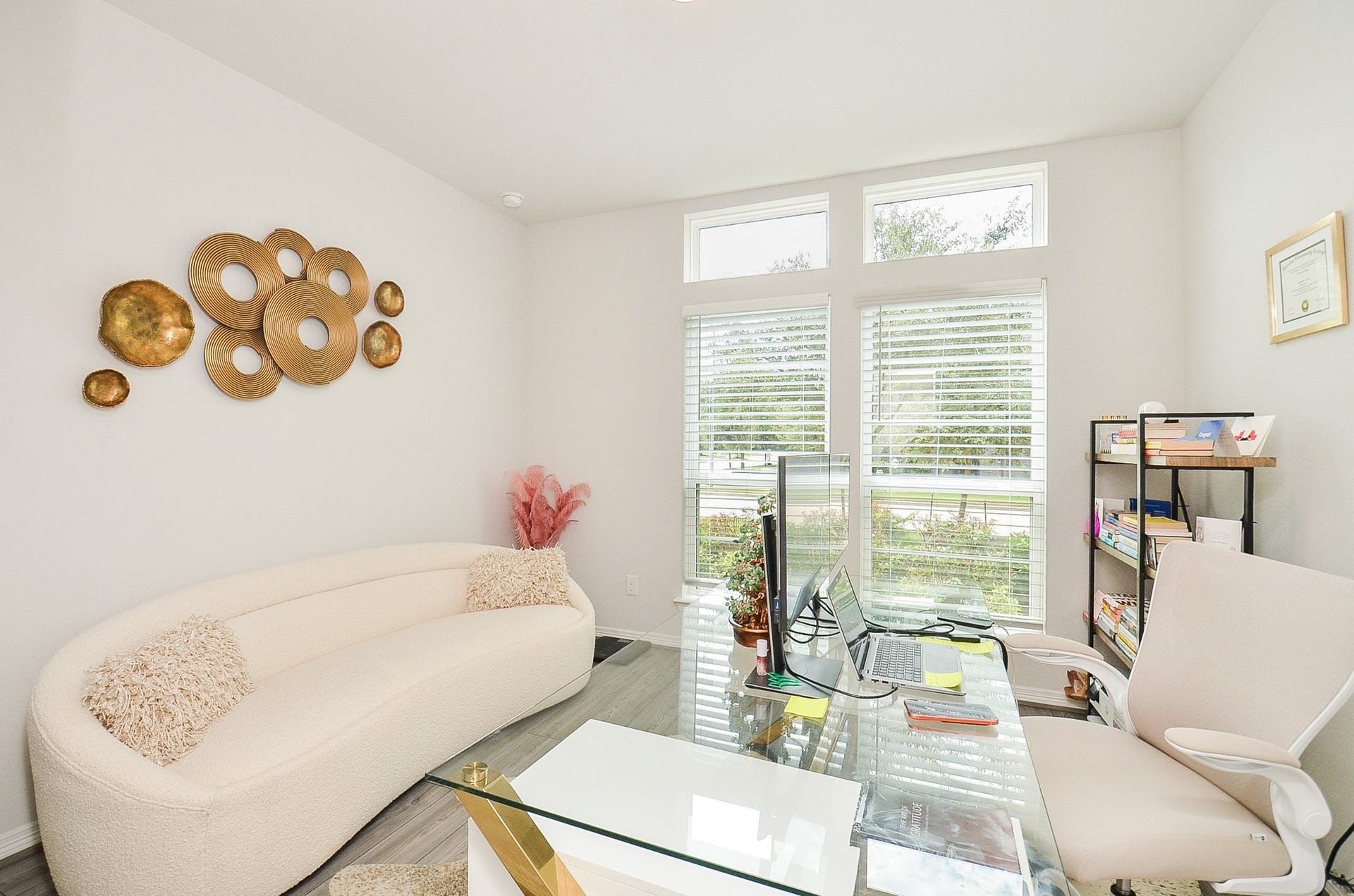 30706 Hawthorn Glen Court, Fulshear, TX 77441 Bright and inviting home office featuring large windows with elegant shutters, a contemporary glass desk, and modern decor for a stylish workspace.