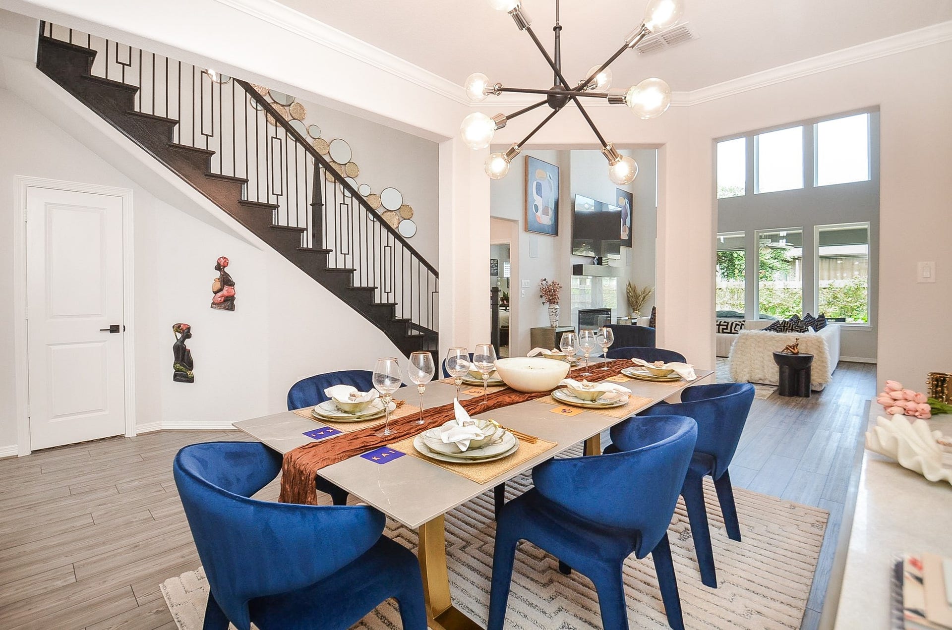 30706 Hawthorn Glen Court, Fulshear, TX 77441 Elegant dining area that seamlessly connects to the bright living room with large windows and a view of the staircase.
