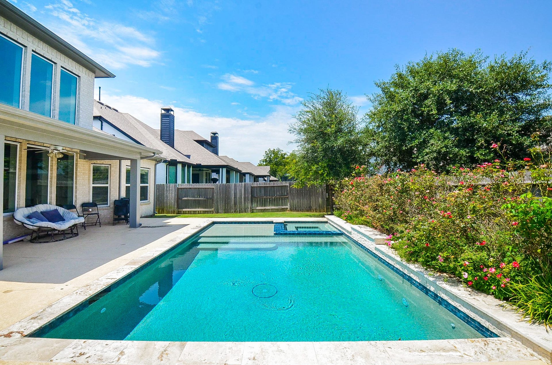 30706 Hawthorn Glen Court, Fulshear, TX 77441 Enjoy a refreshing oasis in your own backyard with this stunning pool, surrounded by lush greenery and a spacious patio perfect for relaxation and entertaining.
