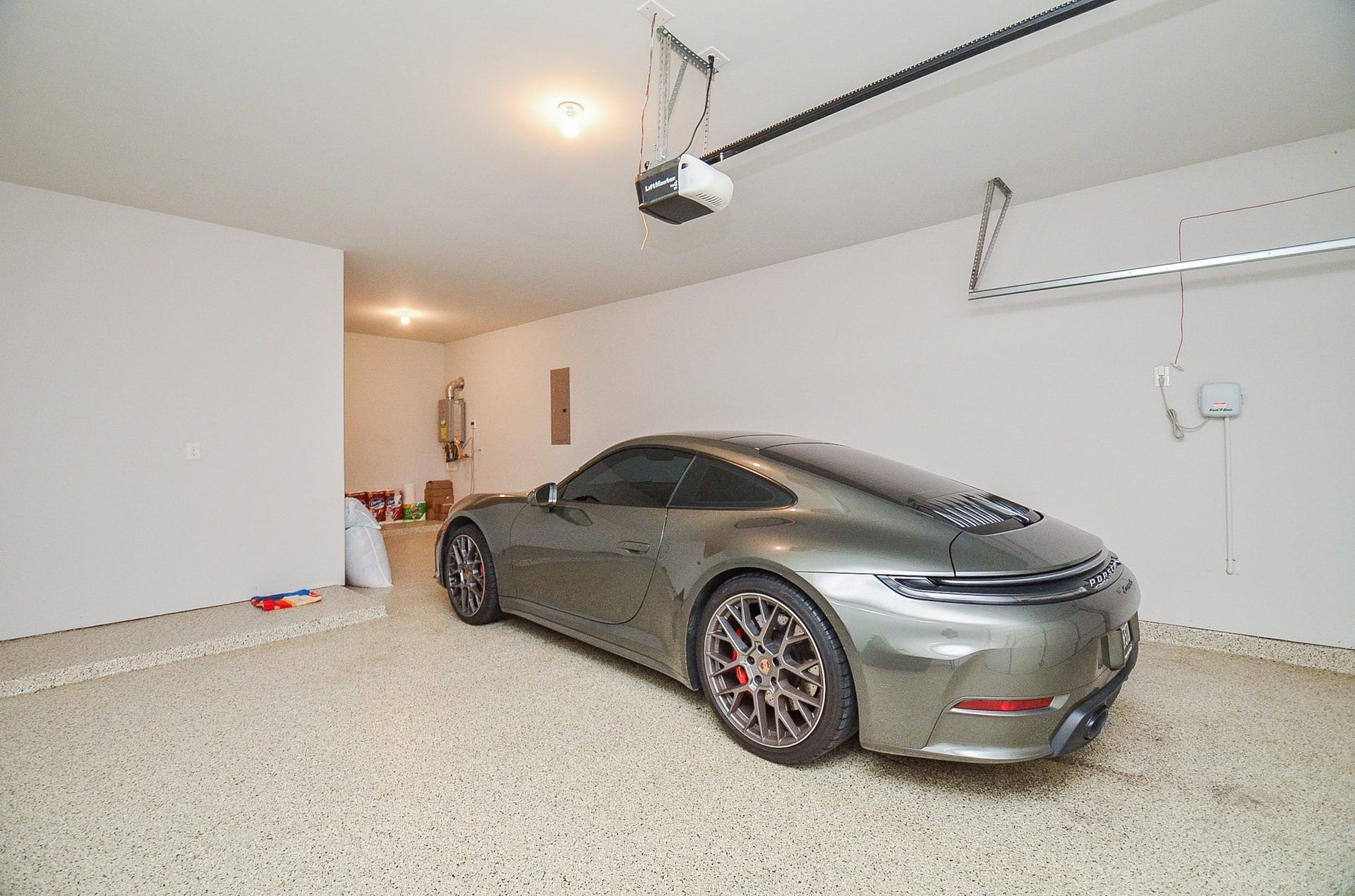 30706 Hawthorn Glen Court, Fulshear, TX 77441 Spacious, well-lit garage with a sleek, modern design and ample room for parking and storage.