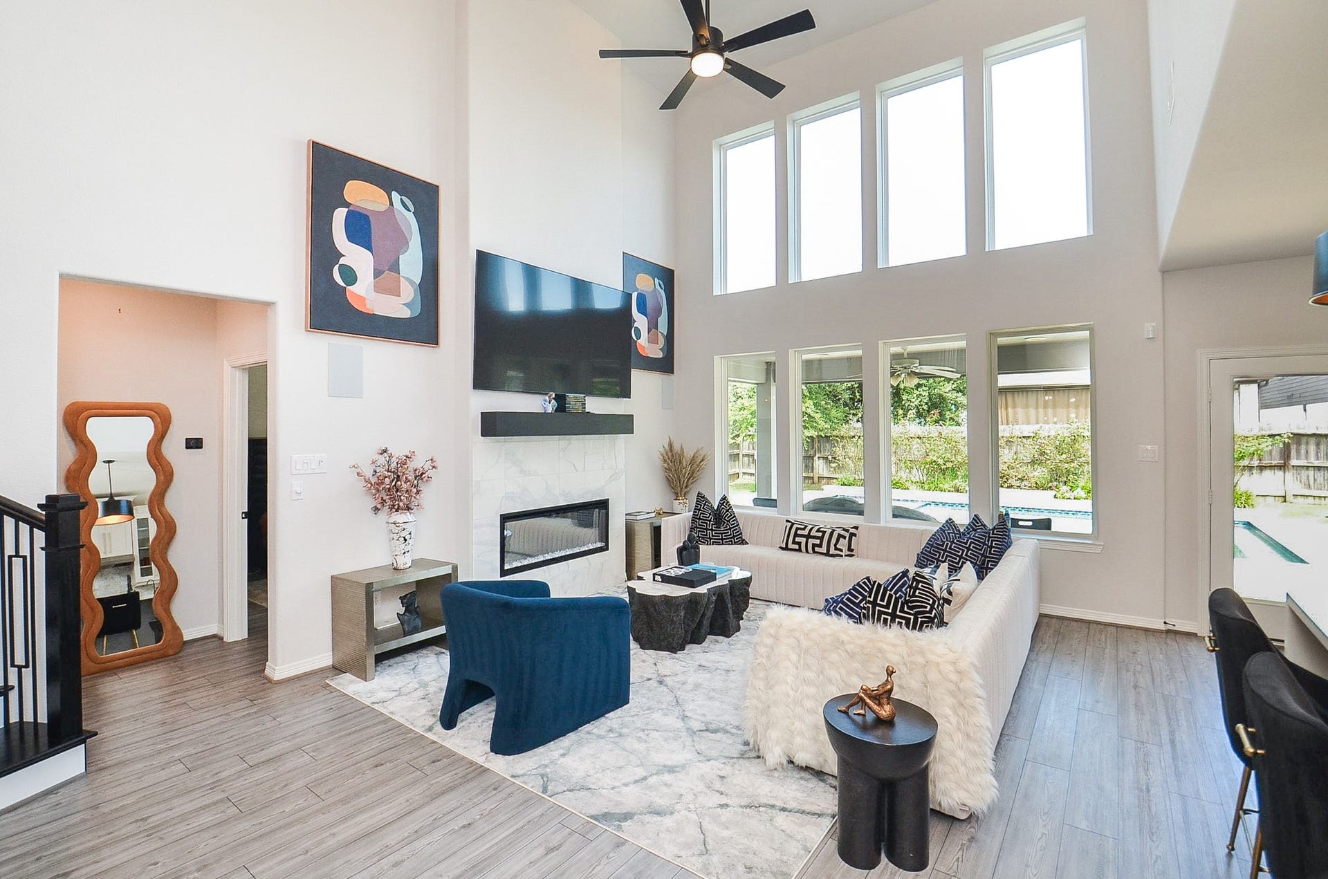 30706 Hawthorn Glen Court, Fulshear, TX 77441 Spacious living room with soaring ceilings, abundant natural light, and a modern fireplace, perfect for entertaining or relaxing.