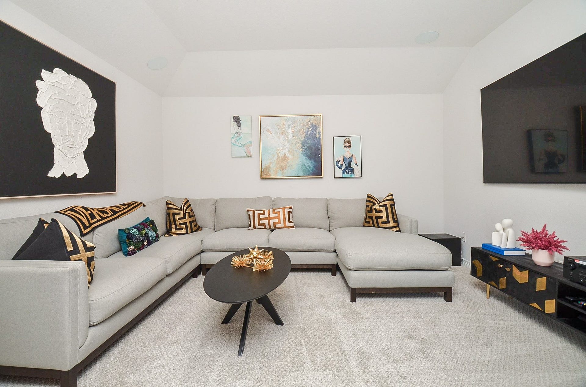 30706 Hawthorn Glen Court, Fulshear, TX 77441 Stylish living room with a modern sectional sofa, chic black coffee table, and vibrant artwork, creating a cozy yet sophisticated ambiance.