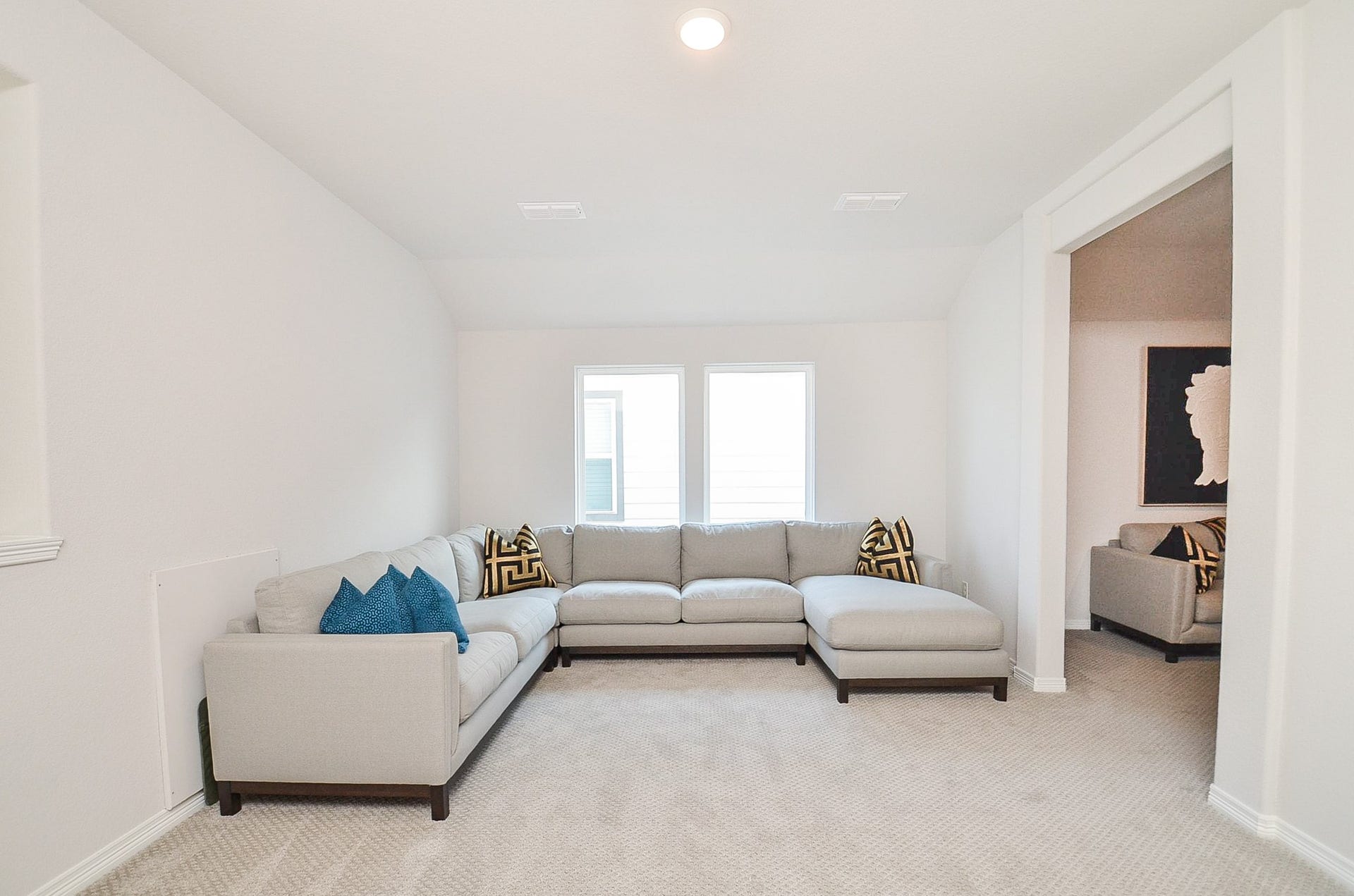 30706 Hawthorn Glen Court, Fulshear, TX 77441 Spacious living area featuring a cozy sectional sofa, plush carpeting, and abundant natural light from two large windows.