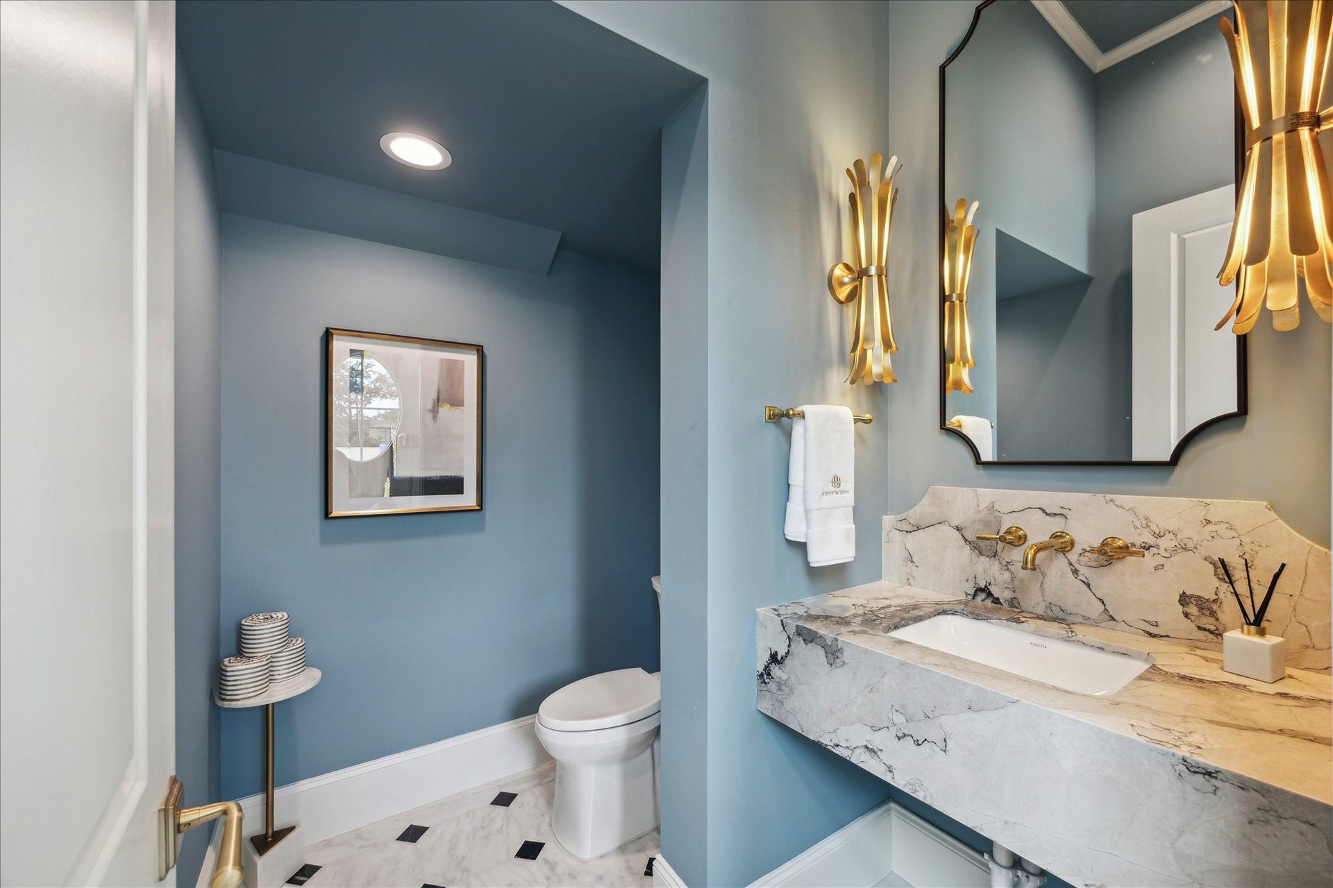 7 Wentworth Gate Path, Houston, TX 77027 First floor powder to feature stone countertop, Kallista luxury fixtures and undermount sink, and additional storage. **Photo is of another home in the community and for information purposes only. Buyer to verify all details.**
