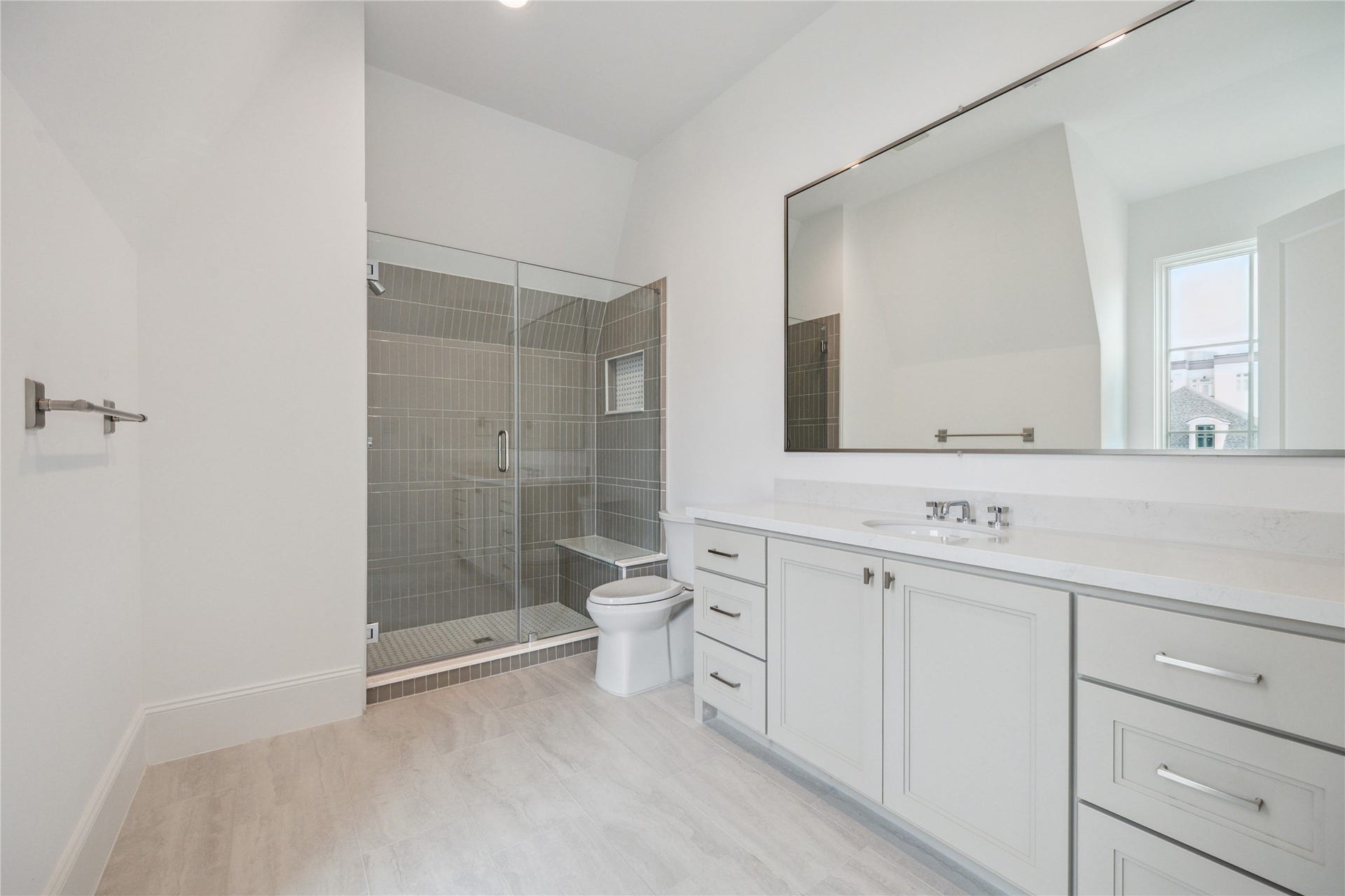 7 Wentworth Gate Path, Houston, TX 77027 Oversized bathroom to feature glass-framed walk-in shower, expansive mirror, and excess storage and counter space. **Photo is of another home in the community and for information purposes only. Buyer to verify all details.**