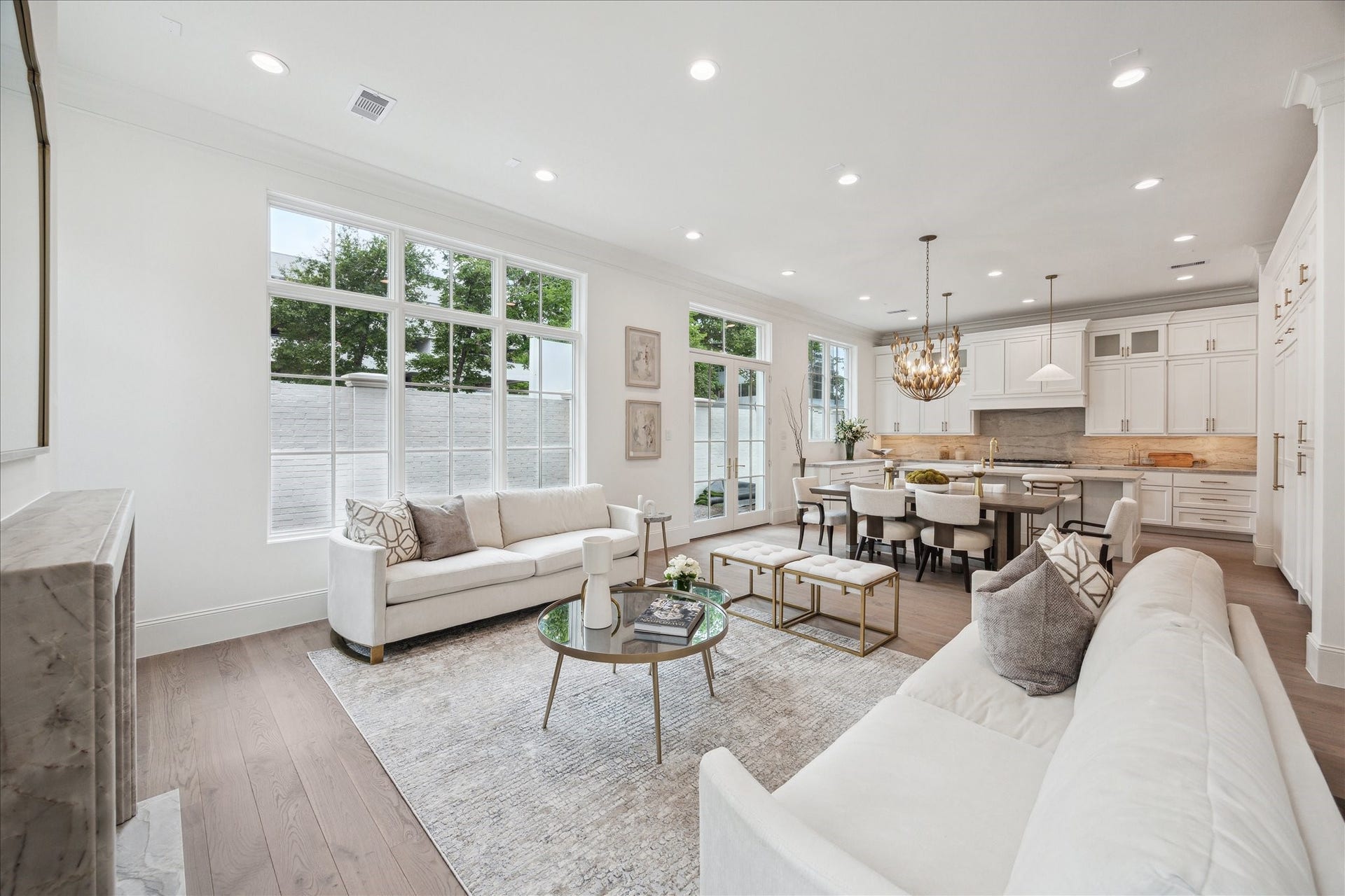 7 Wentworth Gate Path, Houston, TX 77027 The stunning first floor was designed with relaxation and entertaining in mind! Spacious enough for ample seating surrounding the fireplace, a large dining table, and an island with additional seating that overlooks the living space. **Photo is of another home in the community and for information purposes only. Buyer to verify all details.**