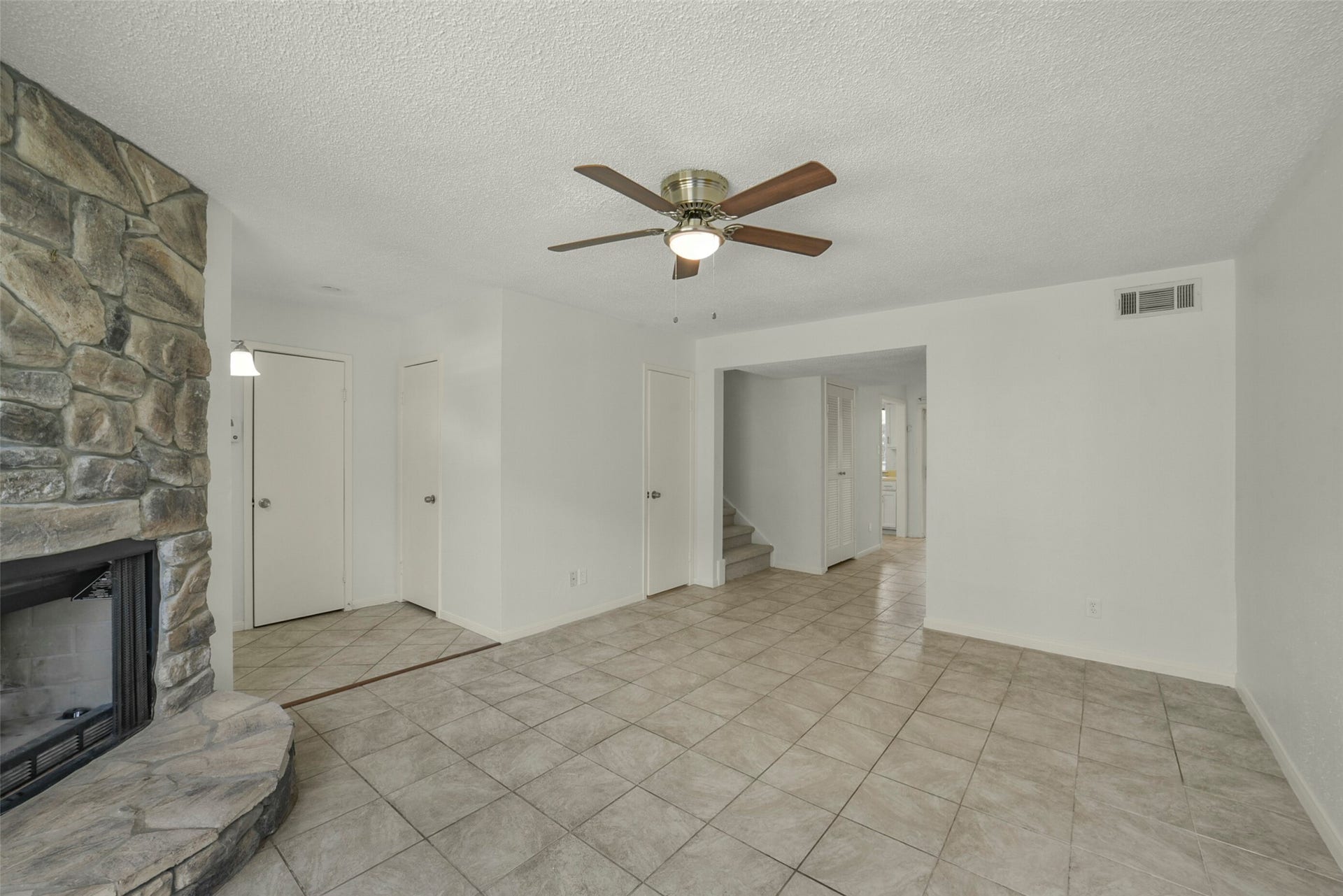 The living room is bright and open. Notice fresh paint throughout.