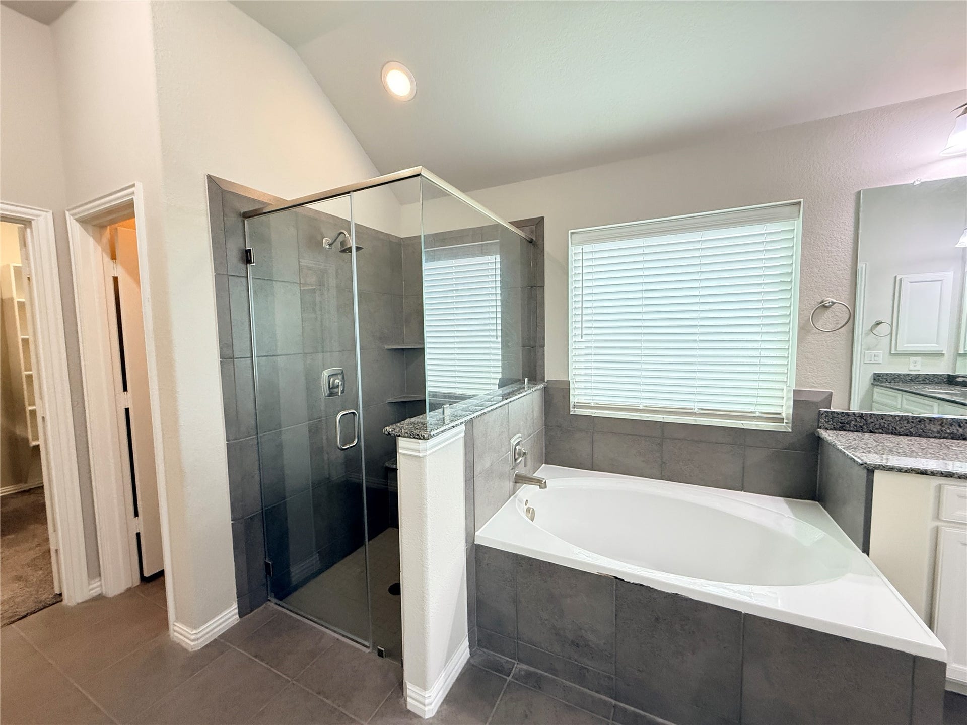 20635 Riley Copper Drive, Cypress, TX 77433 A walk in shower and separate oversized soaking tub with frosted glass for privacy.