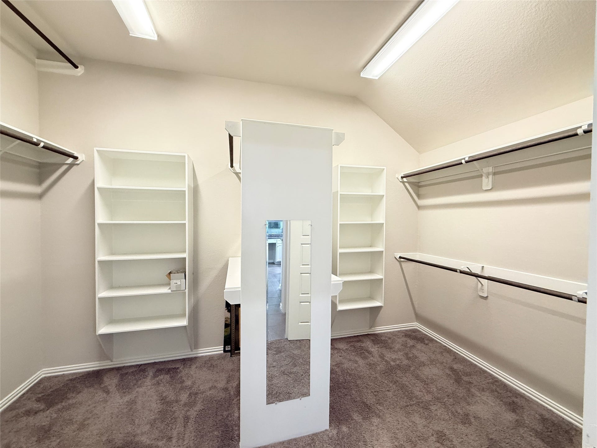 20635 Riley Copper Drive, Cypress, TX 77433 The primary closet is sure to please! There is so much space! Notice the high rack on the left for those items you wear once or twice when the weather dips a bit. There are more racks and shelves behind the mirror.