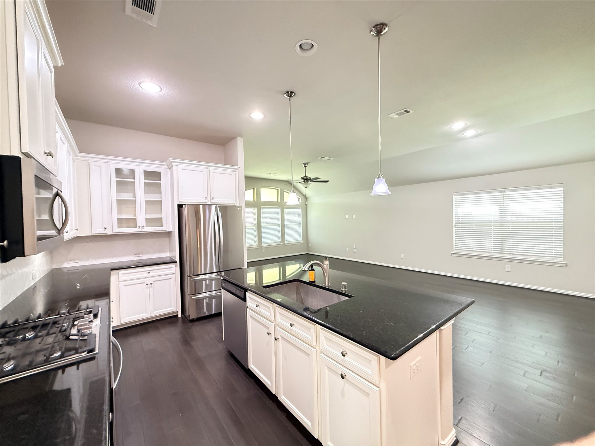 20635 Riley Copper Drive, Cypress, TX 77433 The kitchen has beautiful pendant lighting and high ceilings. It's a great place to prepare your meals. The oven is electric and the cooktop is gas. By the way, the fridge is staying.