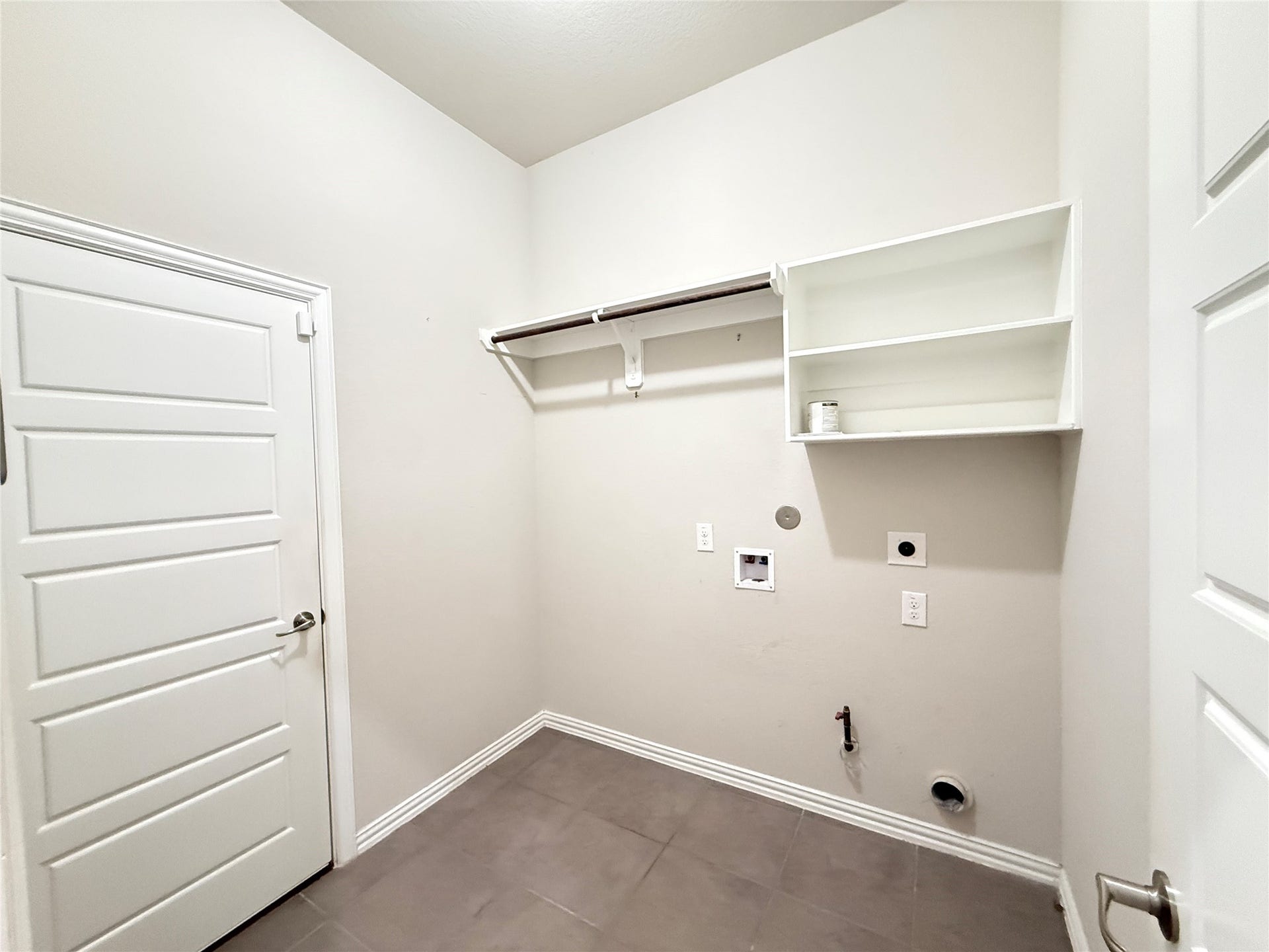 20635 Riley Copper Drive, Cypress, TX 77433 Lots of shelving and hanging space in the laundry. There are gas and electric dryer hook up as well. Door on the left leads out to the attached 2 car garage.