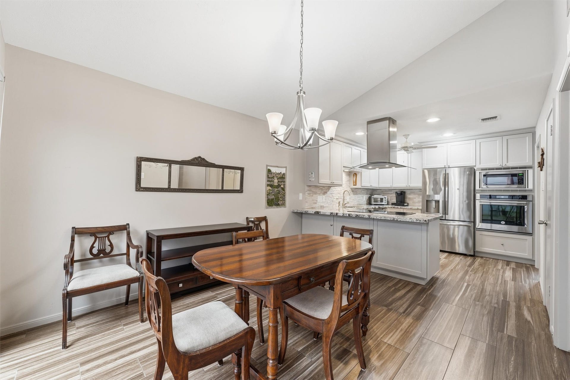 Pretty light filled dining area with upgraded light fixture.