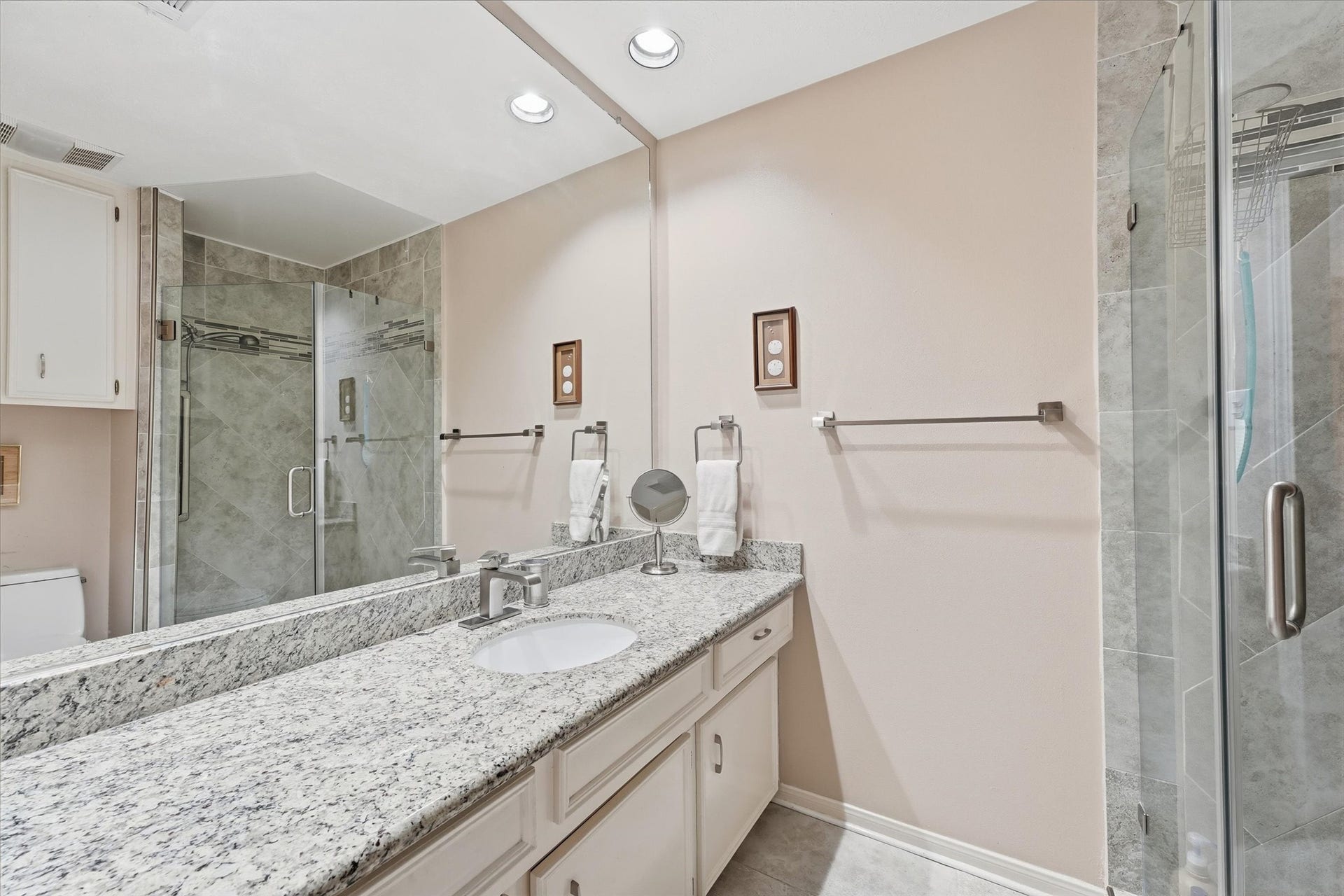 Some primary bath updates include granite counter, undermount sink, & tile floor.