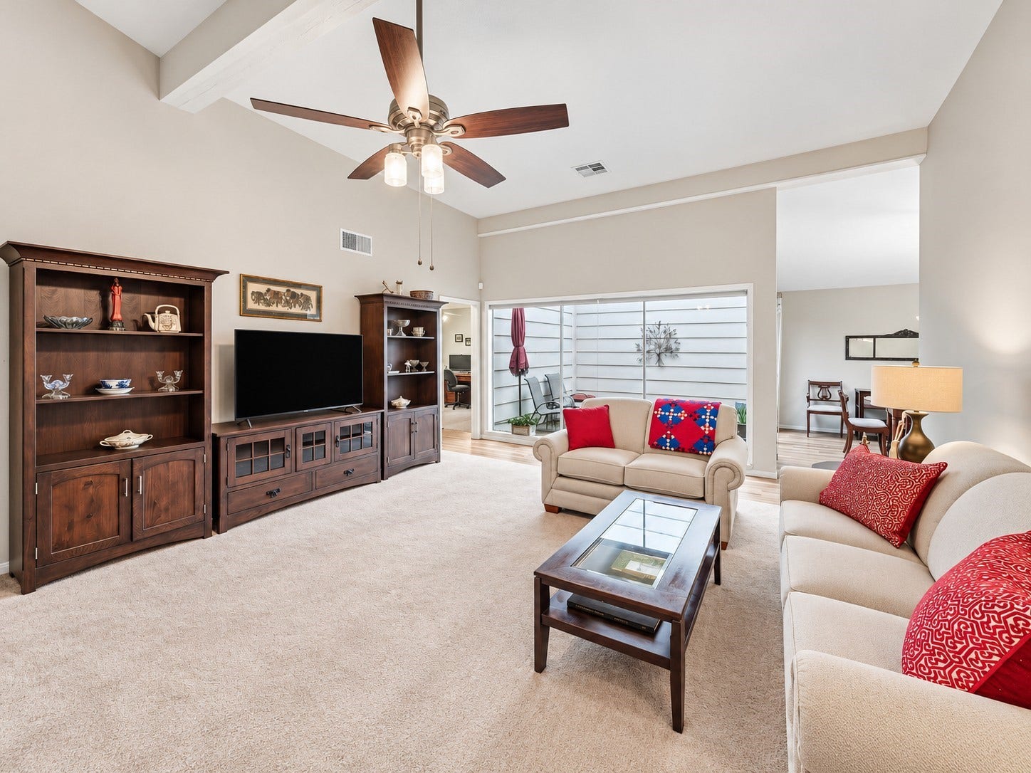 Family room also has a vaulted ceiling, updated ceiling fan & view of the atrium.