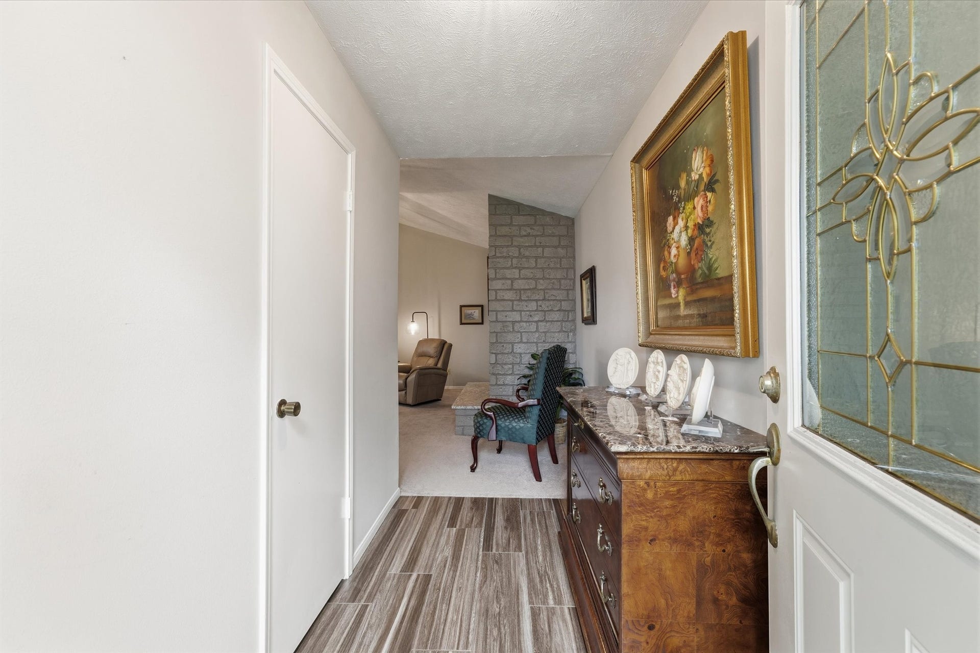 The elegant entry offers a coat closet & welcomes guests to the home.
