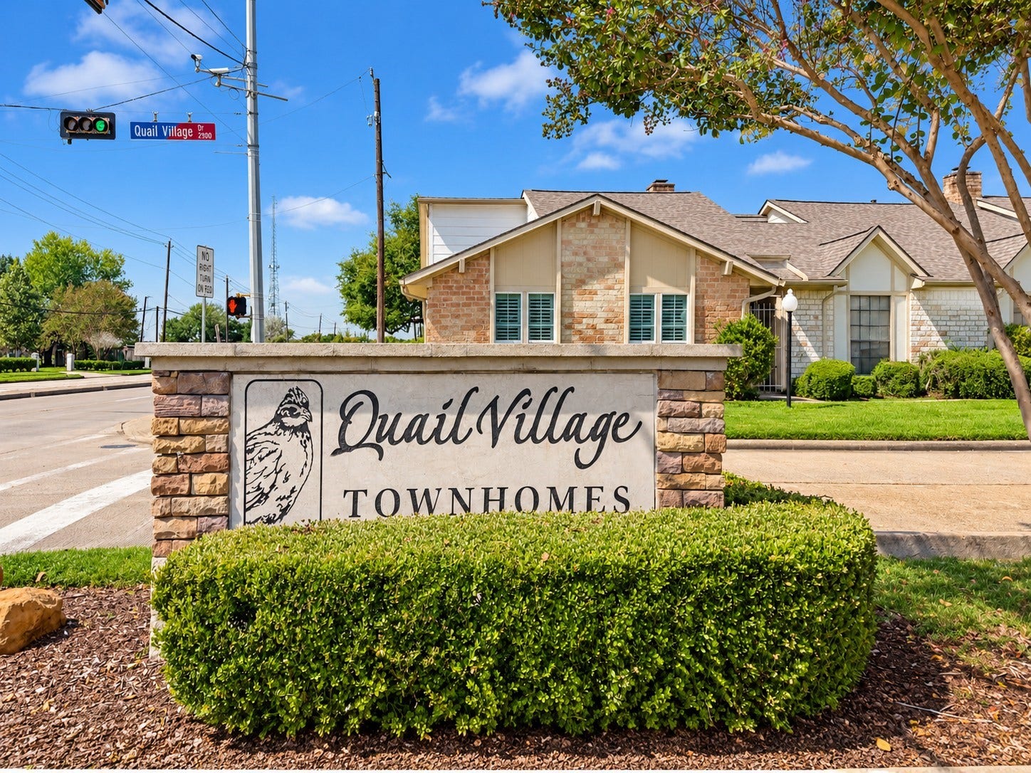 The Quail Village neighborhood entrance leads to the clubhouse & pool.