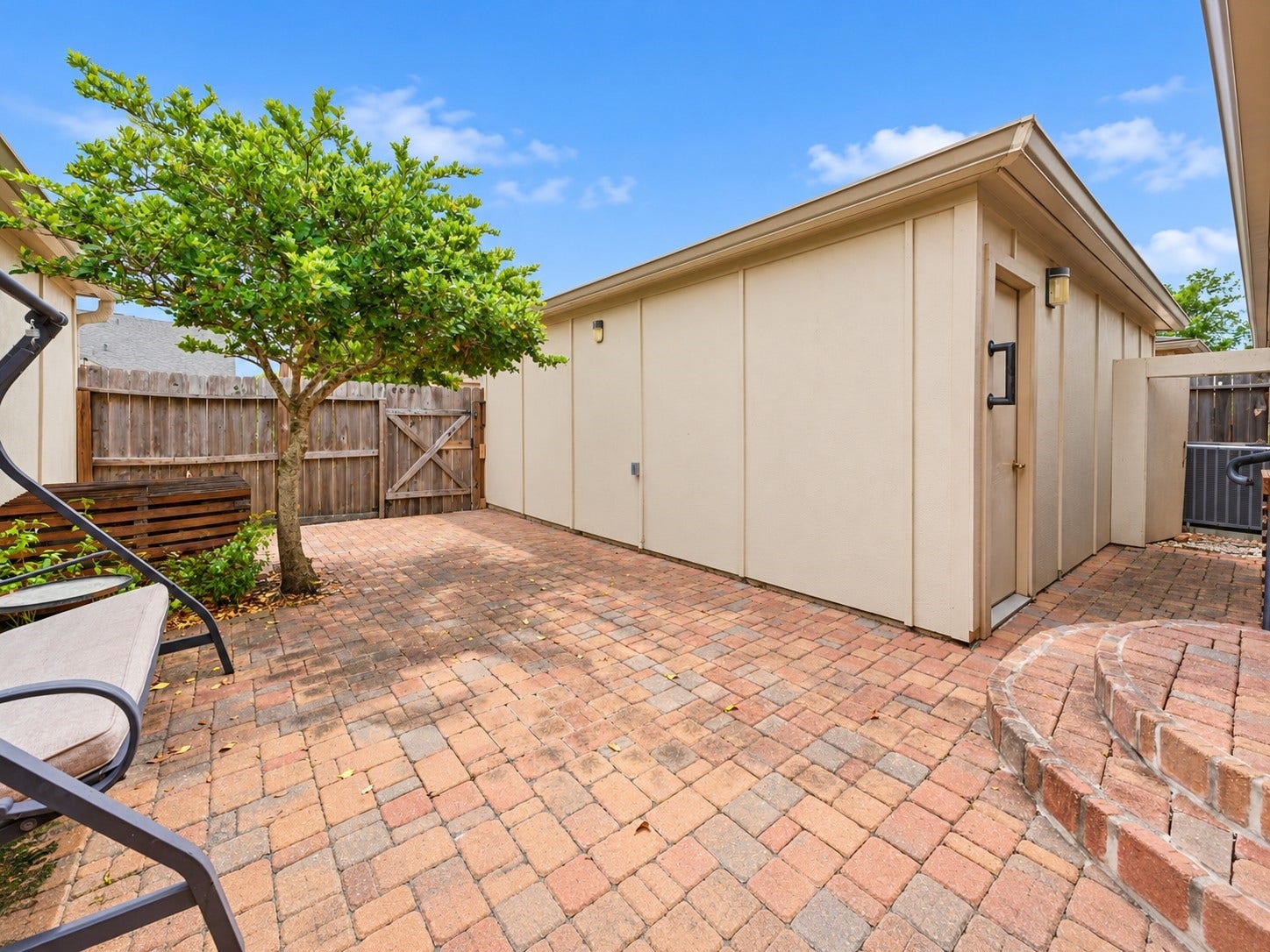 Cobblestone style pavers & shade tree add charm to this wonderful courtyard/back patio with access to the large 2 car garage. Lots of space for various outdoor furniture configurations, too.