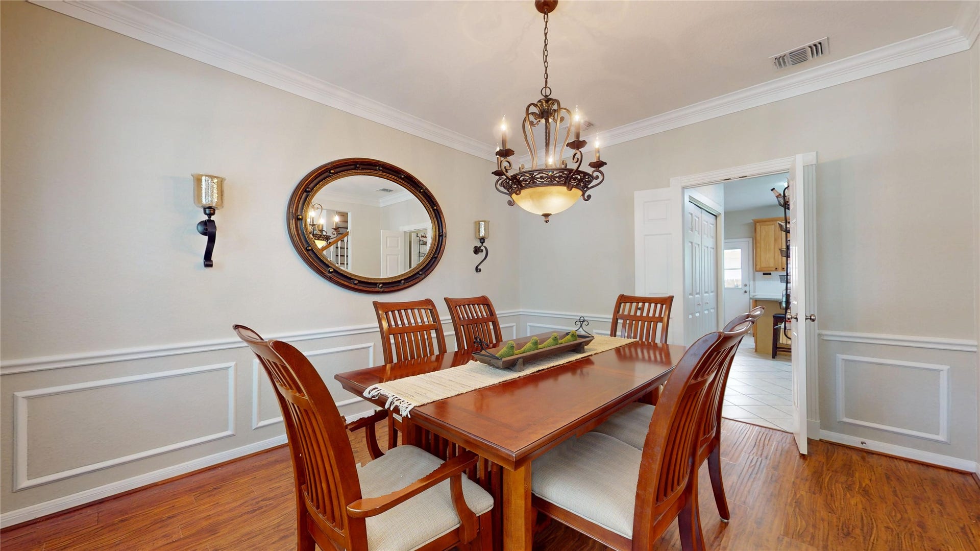 3615 Garrettsville Drive, Pearland, TX 77584 Elegant dining room featuring a stylish chandelier, classic wainscoting, and room for a large table, perfect for gatherings.
