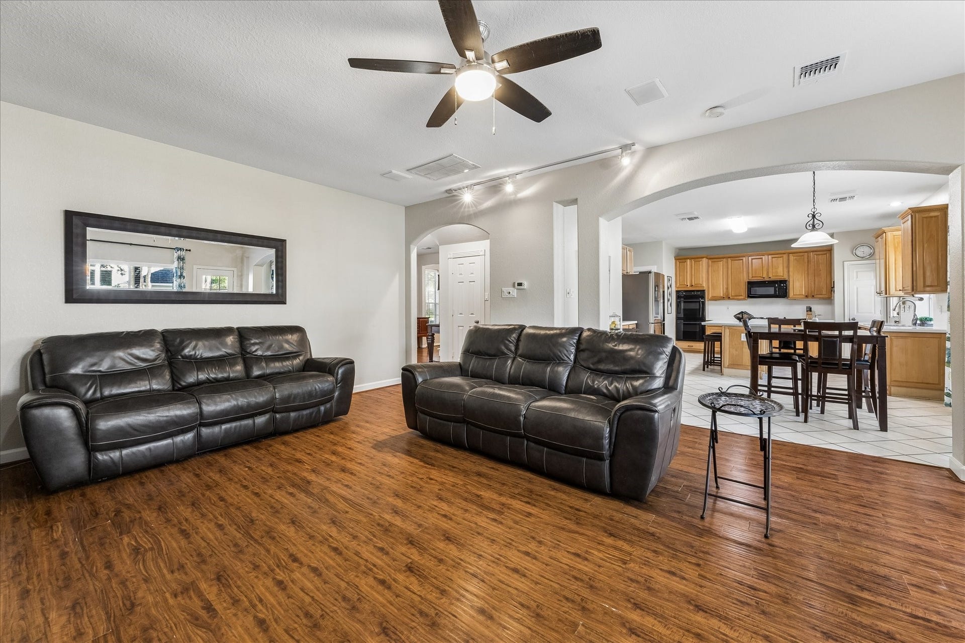 3615 Garrettsville Drive, Pearland, TX 77584 Spacious living area with an open layout leading to a large kitchen, perfect for entertaining and family gatherings.