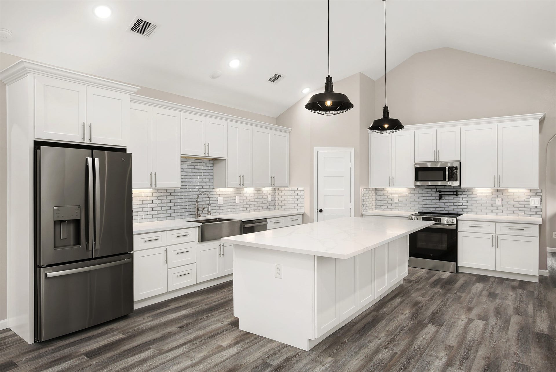 3617 Pecan Drive, Bacliff, TX 77518 Beautiful kitchen with quartz countertops, glass tile backsplash, under cabinet lighting, stainless steel appliances, and oversized 9x5 island