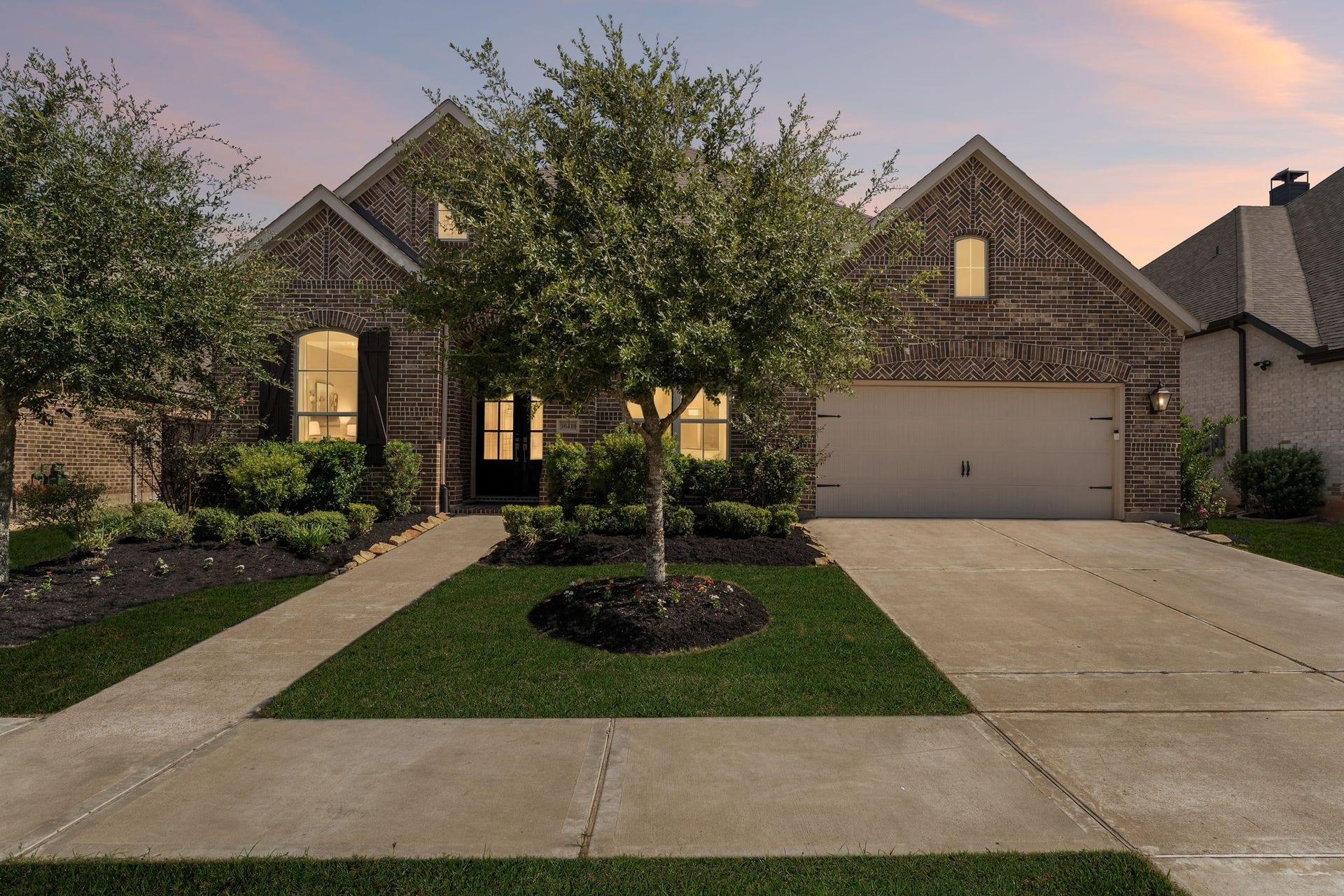 30410 Myrtle Oak Drive, Fulshear, TX 77423 This stunning residence features exquisite brickwork and charming architectural accents that provide immediate curb appeal and a warm, inviting atmosphere from the moment you arrive.