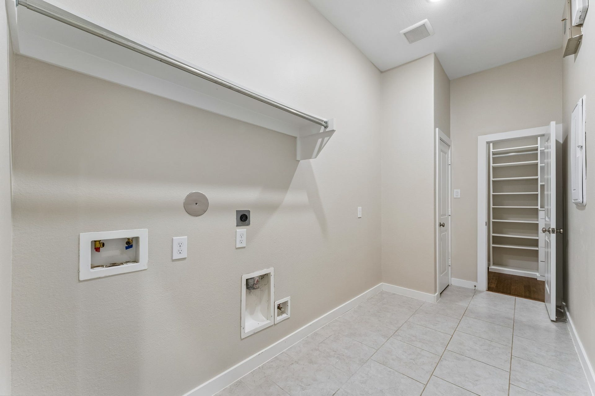 30410 Myrtle Oak Drive, Fulshear, TX 77423 Exceptional laundry utility room has space for a freezer and connects to the primary closet for ultimate convenience.