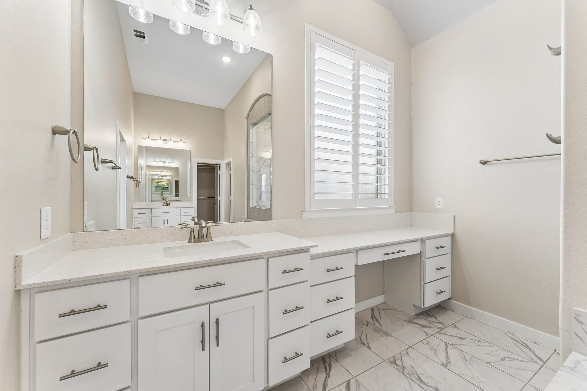 30410 Myrtle Oak Drive, Fulshear, TX 77423 Luxury vanity area featuring a large, statement mirror and abundant natural light, perfect for your daily routine.