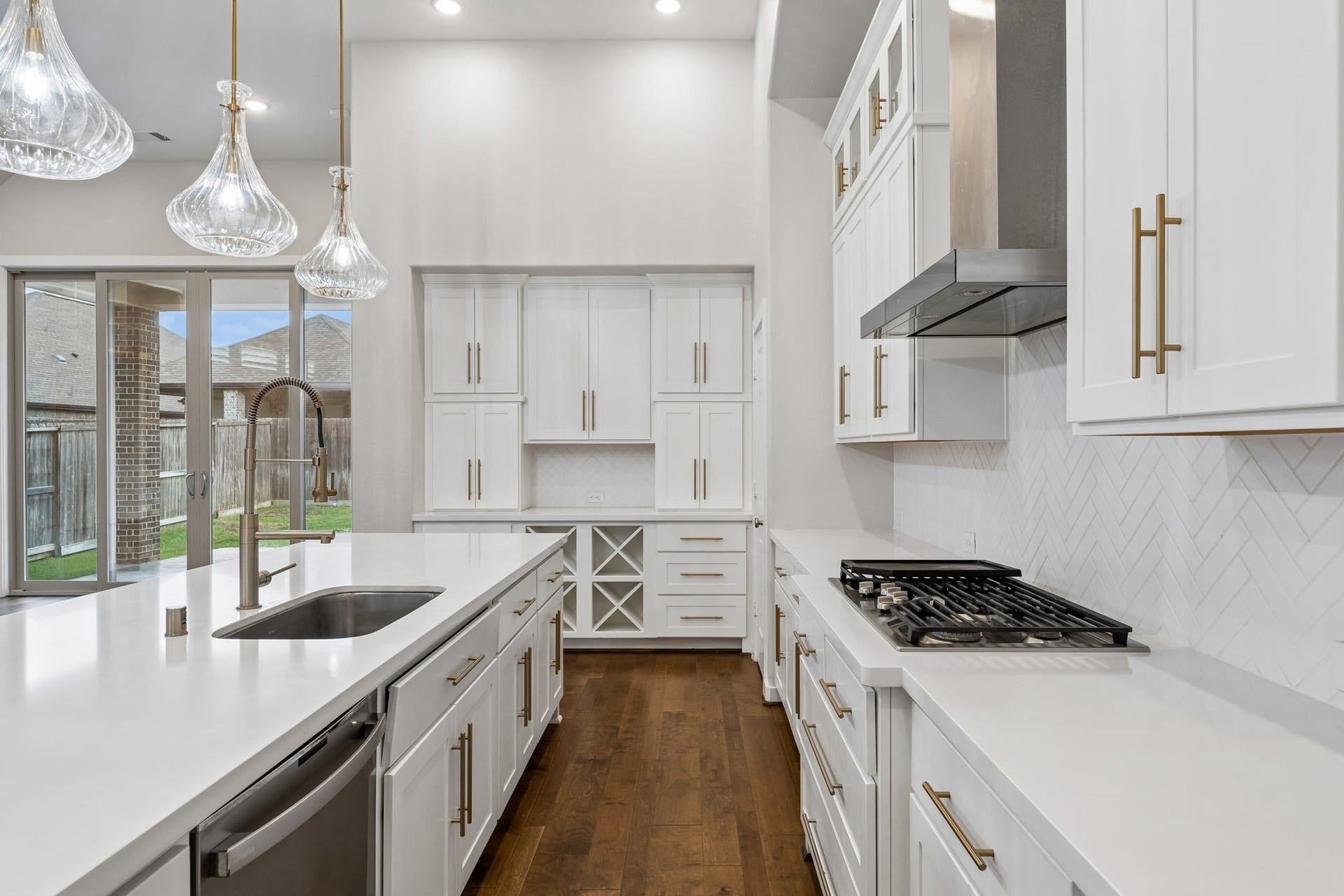 30410 Myrtle Oak Drive, Fulshear, TX 77423 Chef's kitchen featuring a premium gas cooktop with an integrated griddle, perfect for gourmet cooking. As well as a lovely serving area that perfectly compliments the kitchen, providing an ideal space for entertaining and casual dining.