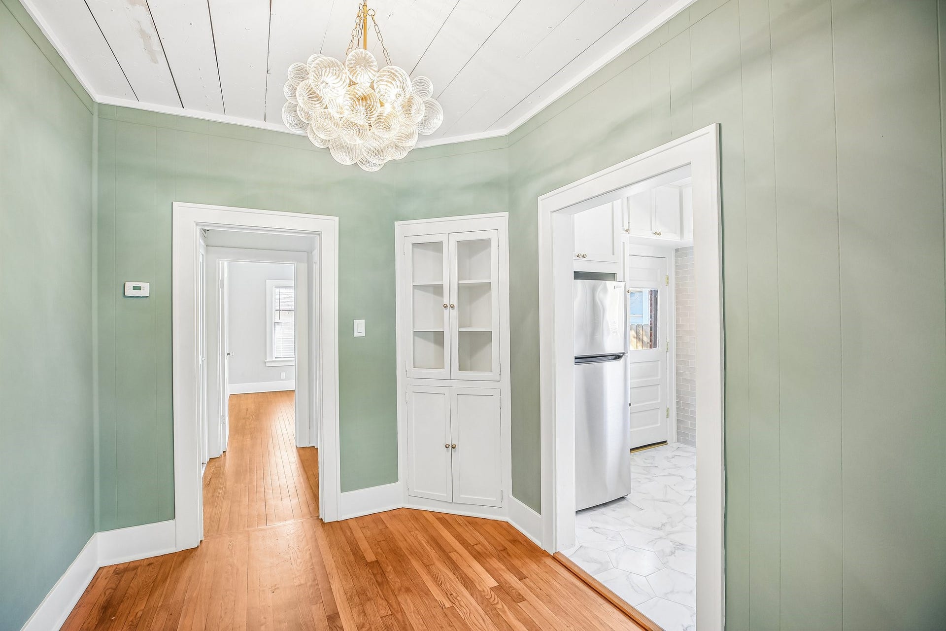 1104 Key Street, Houston, TX 77009 The dining room is darling with it's original corner hutch, shiplap ceilings and whimsical chandelier.
