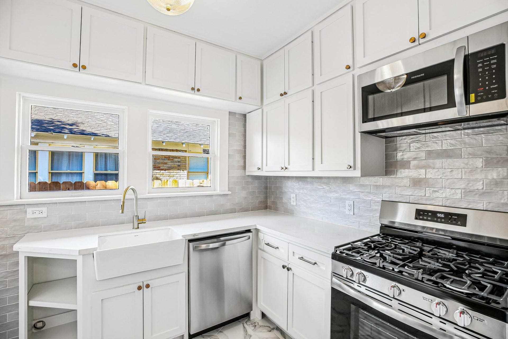 1104 Key Street, Houston, TX 77009 The kitchen is all-Heights with marble flooring and an updated version of the classic subway. Cabinets, also all-new, are crafted on site and done in the traditional "old Heights" Shaker style. The sink is farmhouse style. There is a door to the backyard to the left of the angled cabinet straight ahead (not pictured).