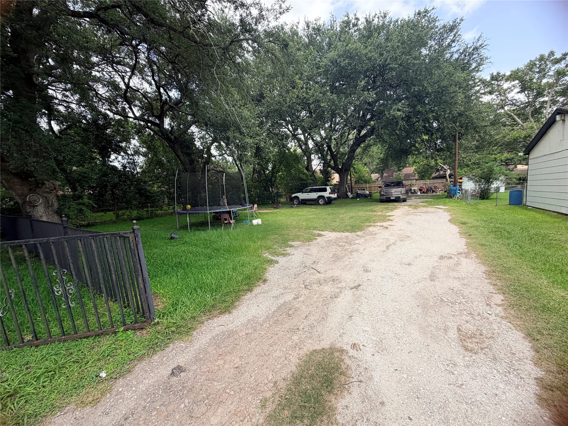 1207 Pirtle Street, La Marque, TX 77568 The existing driveway provides convenient access to the property, with mature trees adding character and natural shade.