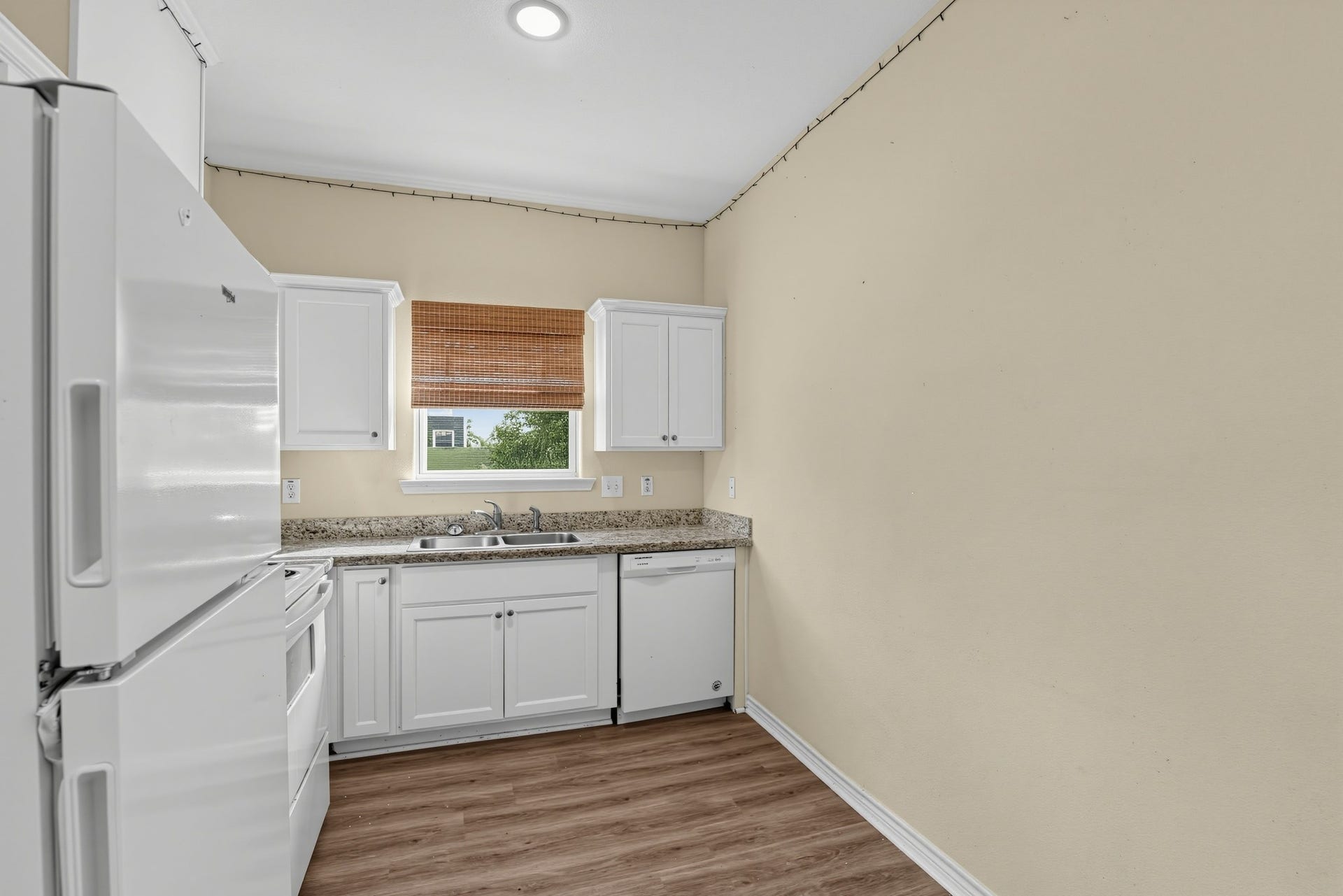 3717 Church Street Street, Galveston, TX 77550 Kitchen has ample cabinet space, natural light, and a stainless steel sink.