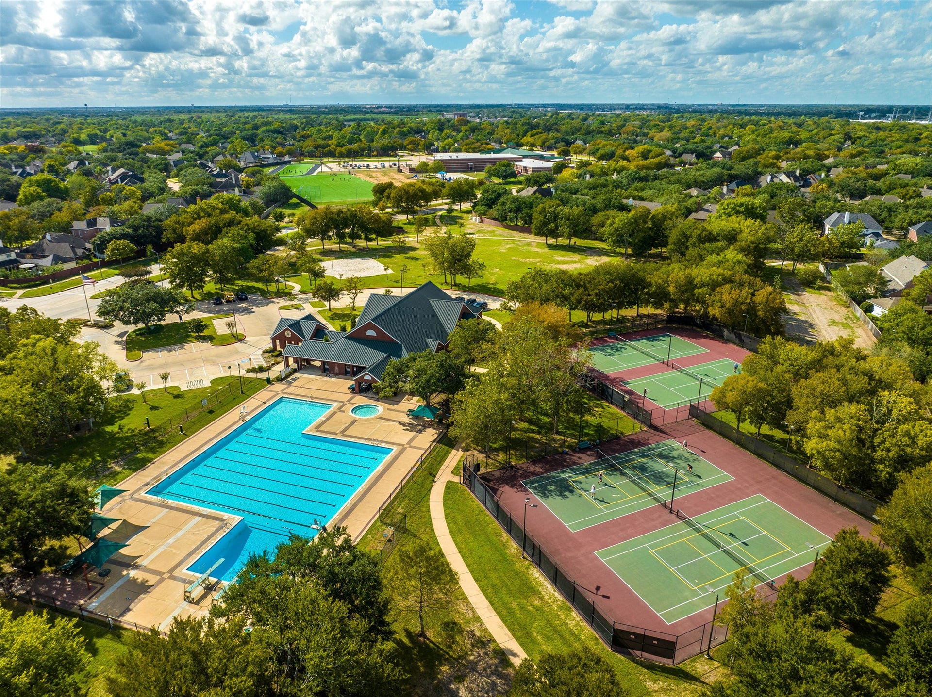 7715 BAYOU GREEN LANE, Sugar Land, TX 77479 MULTIPLE TENNIS COURTS, A SPACIOUS CLUBHOUSE, AND A LAP POOL WITH DEDICATED LANES.