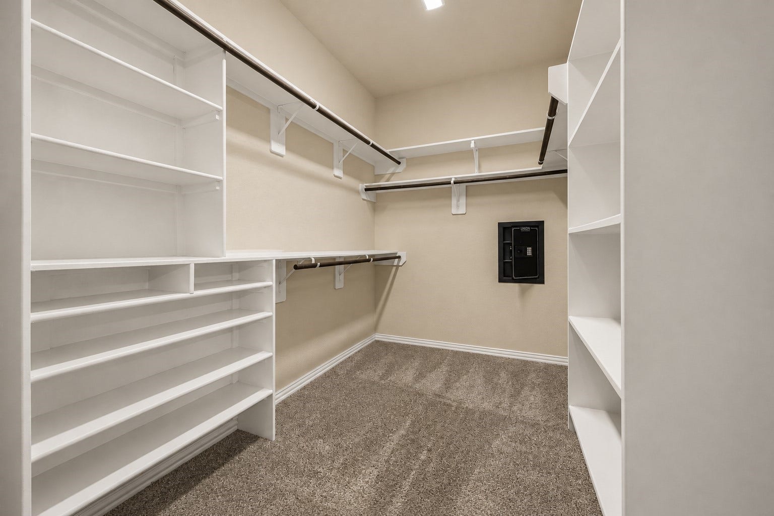 655 W Linnwood Drive, Woodbranch, TX 77357 Spacious primary walk-in closet with built-in shelving, abundant storage, and a wall safe for added security!