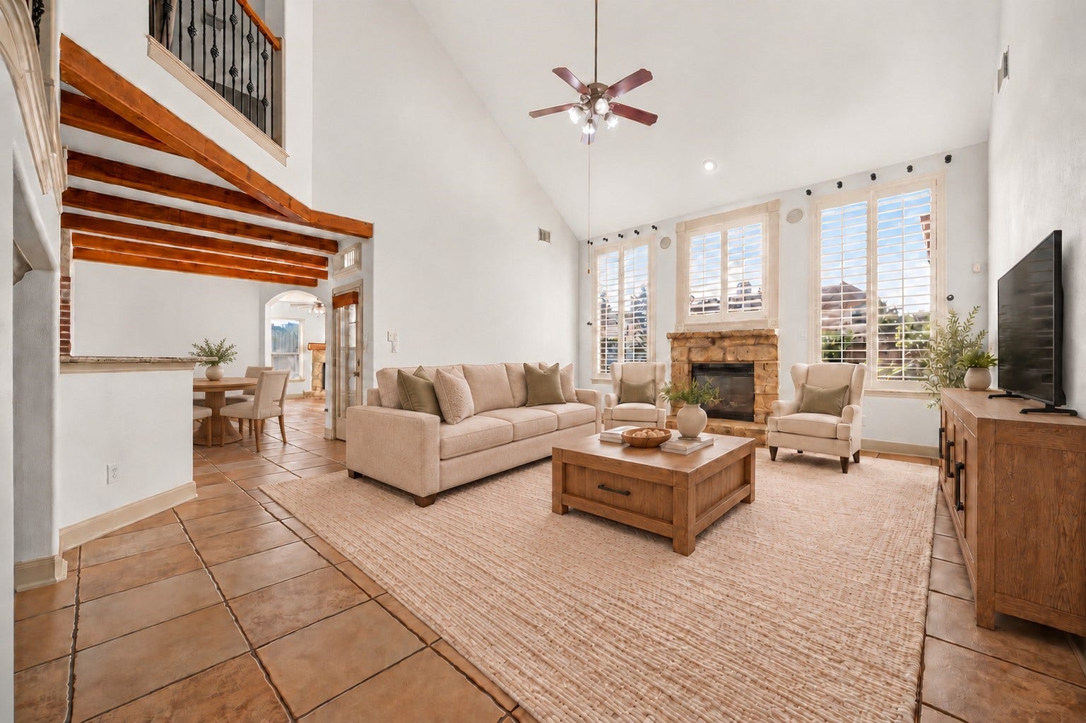 11803 Silverwood Bend Lane, Cypress, TX 77433 Spacious living room with high ceilings, a cozy stone fireplace, and abundant natural light from large windows, seamlessly connected to the kitchen and breakfast room.